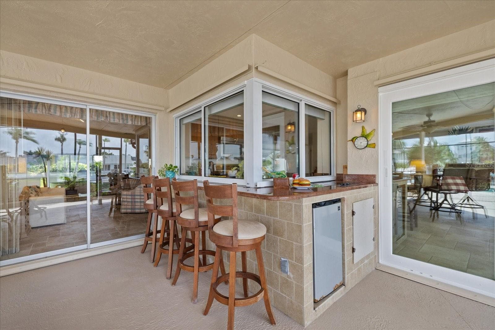 Pass through windows to Outdoor electric jen-air cooktop, frig and bar area. - 3154 TRIDENT TER, NEW PORT RICHEY