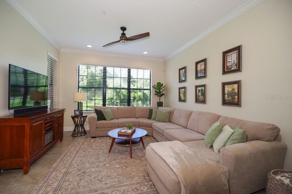 LIVING ROOM WITH VIEWS OF CONSERVATION, GOLF AND WATER - 1541 CORKERY CT #1541, WINTER SPRINGS