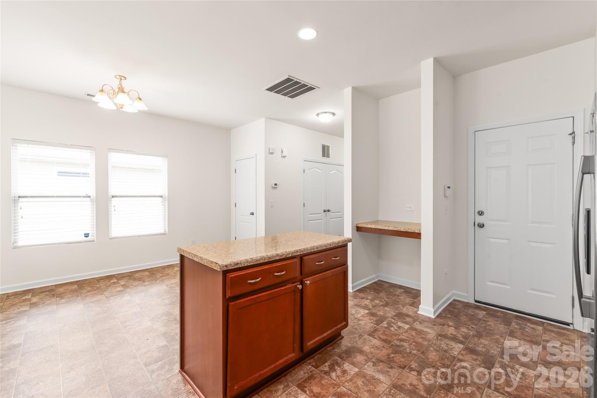 In the kitchen looking into the dining space. Note the closet for storage! - 8411 Romana Red Lane, Charlotte