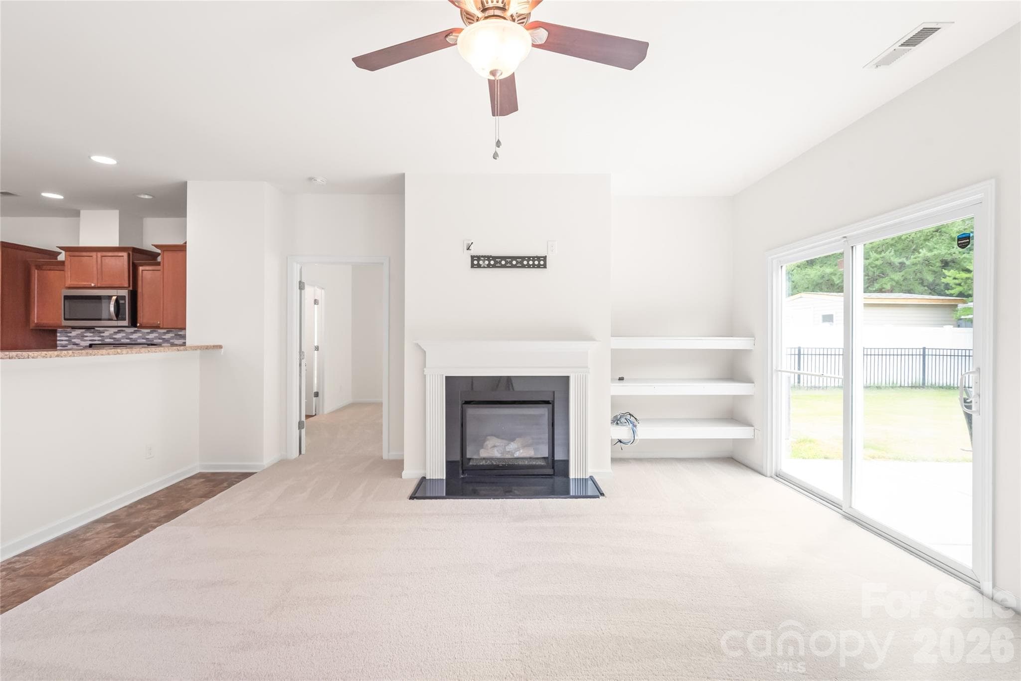 The living room has great built-in shelves and a gas log fireplace. - 8411 Romana Red Lane, Charlotte