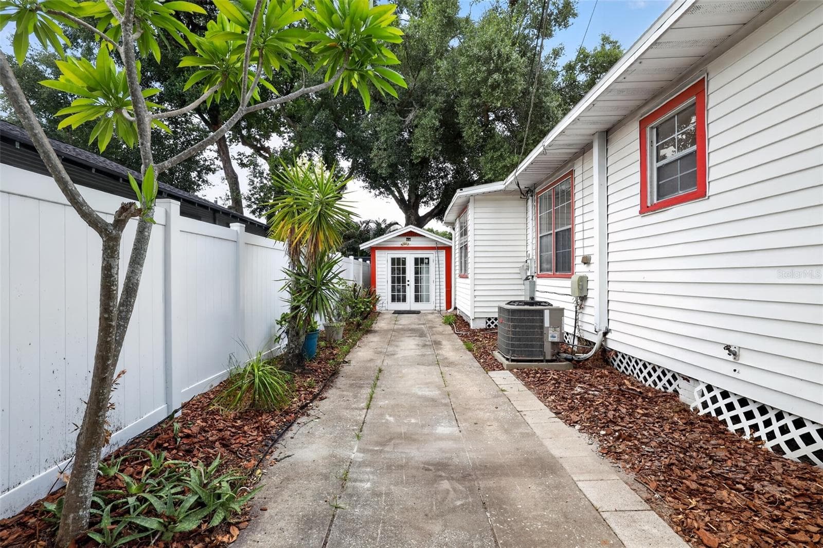 Private side walkway leading to the detached garage in this 1922 bungalow - 813 E NEW ORLEANS AVE, TAMPA