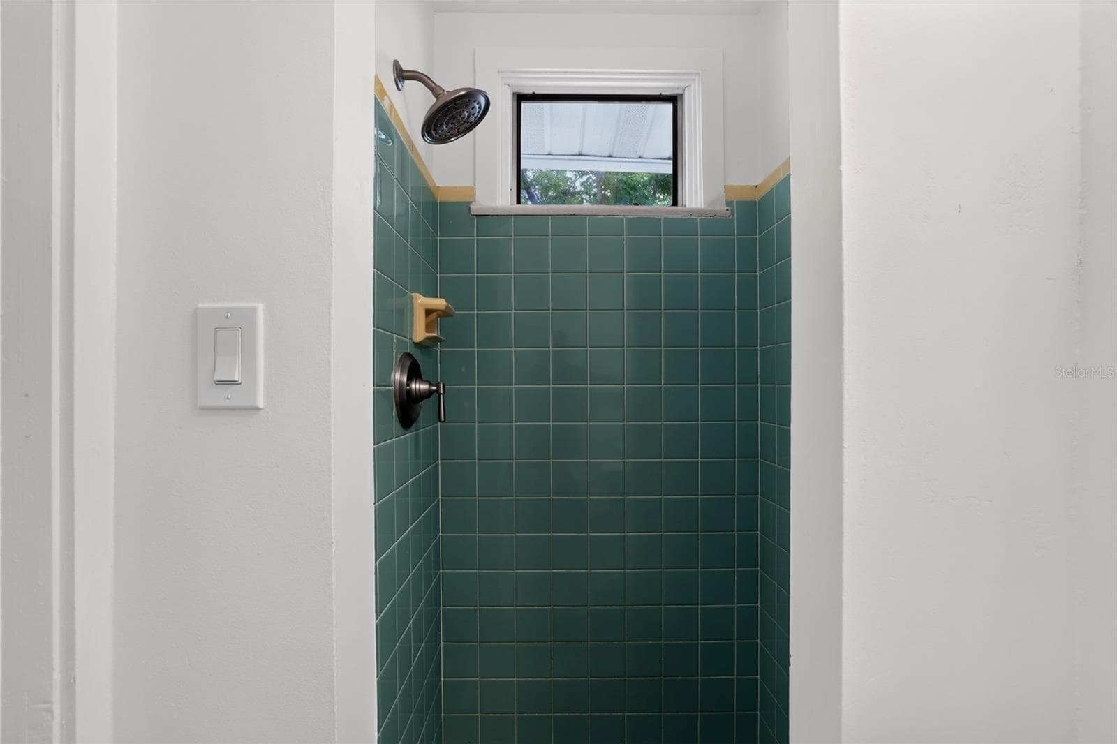 Green tile shower in the second bathroom of this 1922 bungalow - 813 E NEW ORLEANS AVE, TAMPA