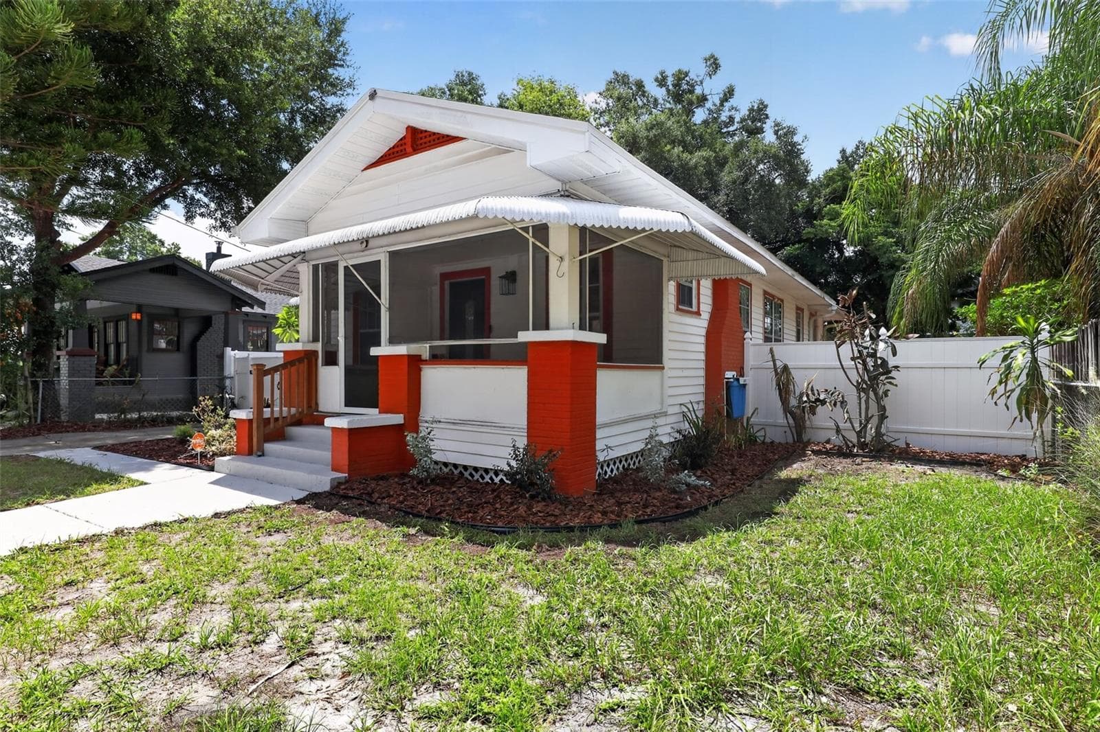 Charming front elevation of this classic 1922 bungalow with covered porch and distinctive red accents - 813 E NEW ORLEANS AVE, TAMPA