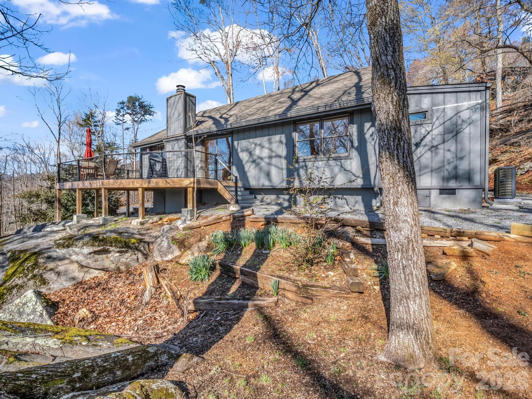 Where architecture meets nature—this home is uniquely grounded among impressive natural rock formations." - 456 Youngs Mountain Drive, Lake Lure
