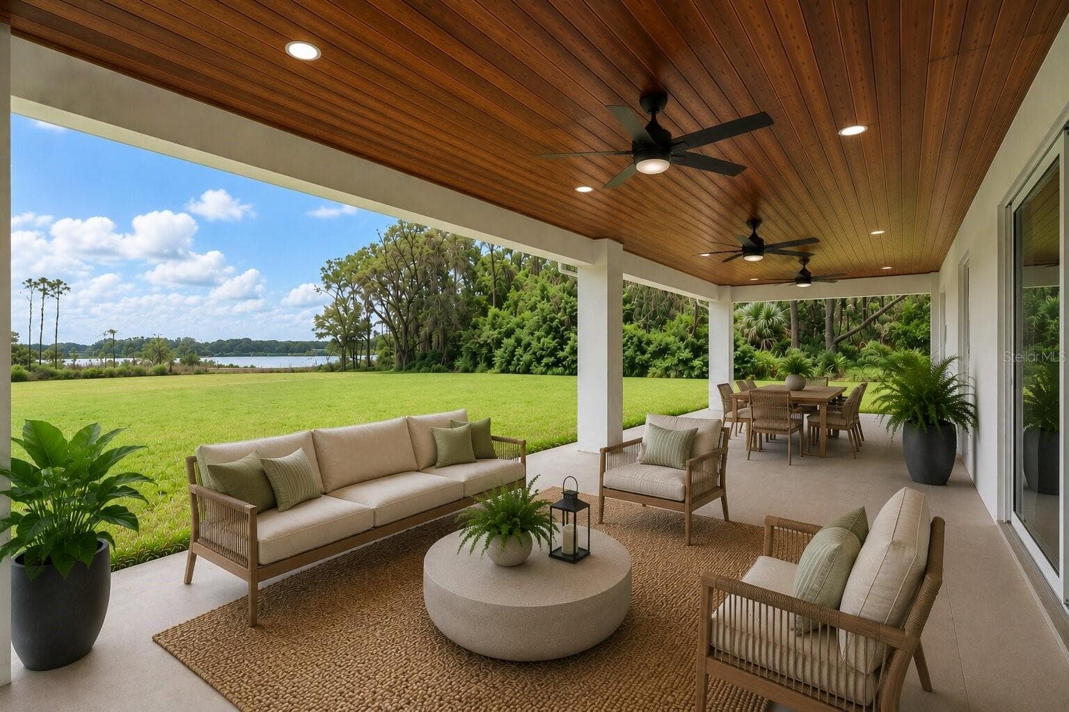 The expansive covered lanai offers the perfect setting for relaxing, entertaining, and taking in peaceful lake views. (Virtual staging shown) - 39251 COUNTY ROAD 439, UMATILLA
