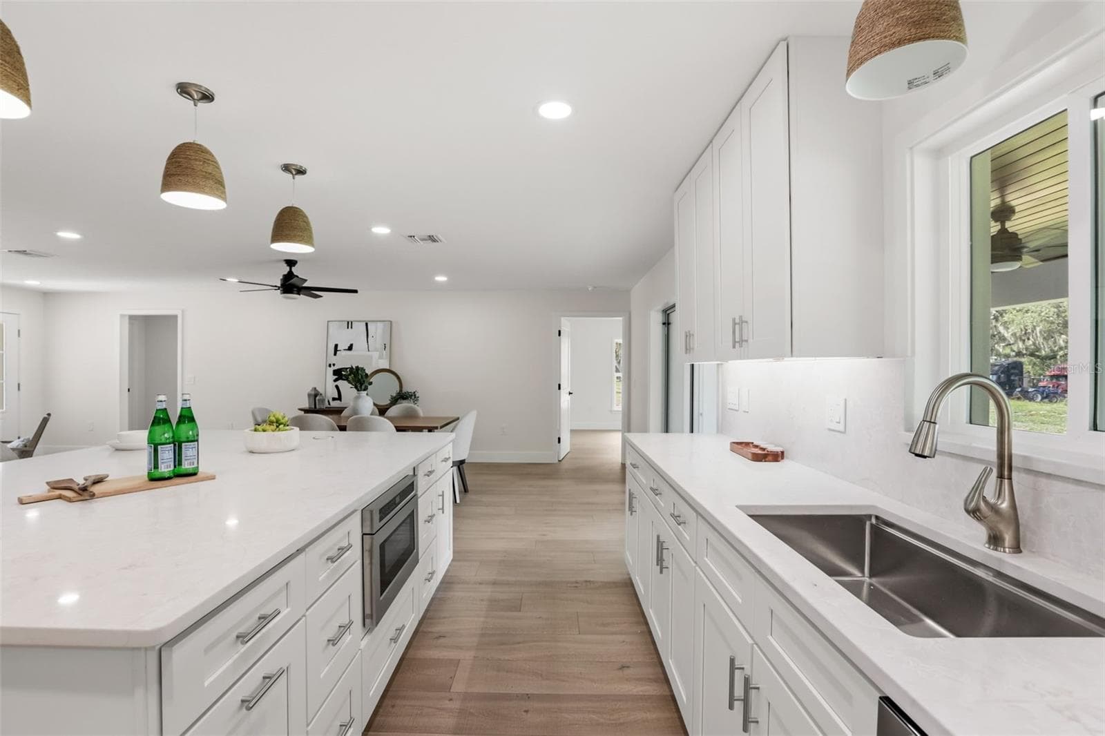 Another view of the beautifully designed kitchen showcasing its generous workspace, custom cabinetry, and timeless finishes. - 39251 COUNTY ROAD 439, UMATILLA