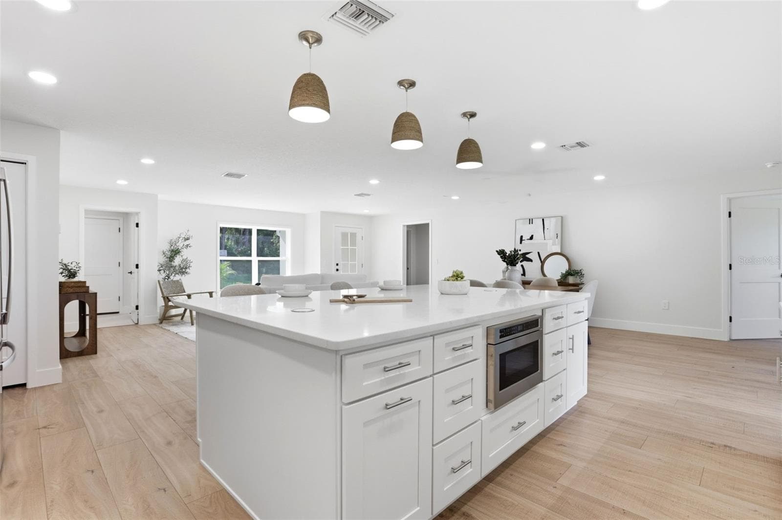 The open-concept living and dining areas are filled with natural light - 39251 COUNTY ROAD 439, UMATILLA
