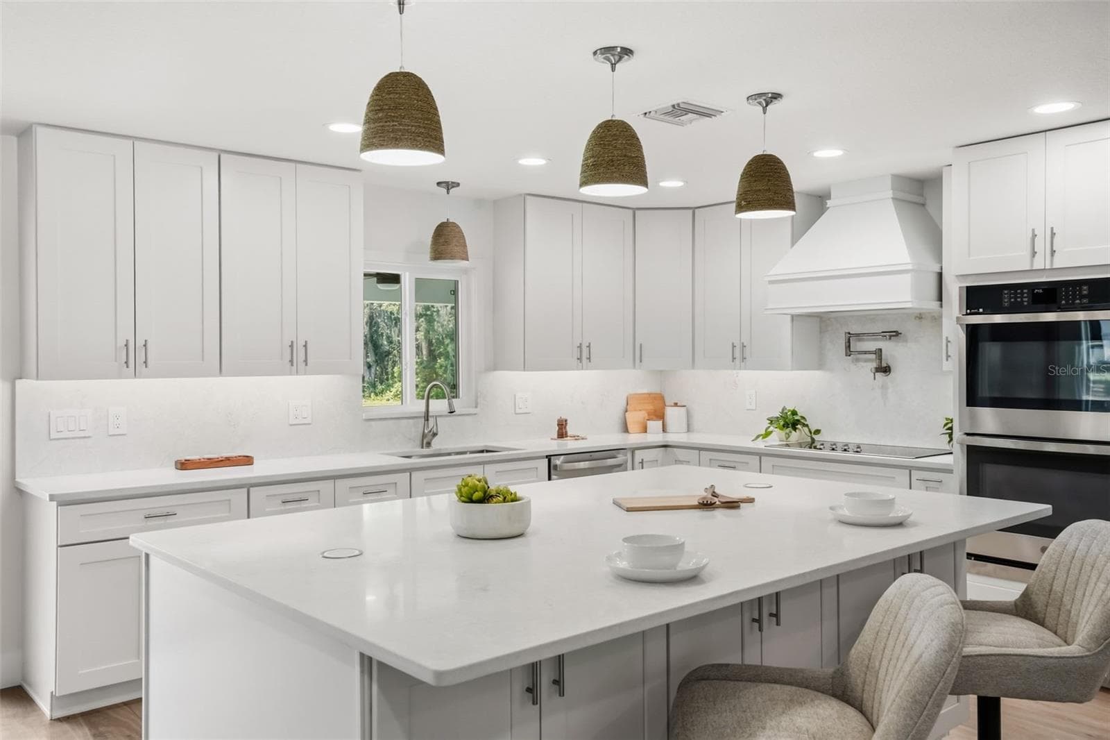 The oversized island, quartz surfaces, and custom cabinetry make this kitchen as functional as it is beautiful - 39251 COUNTY ROAD 439, UMATILLA