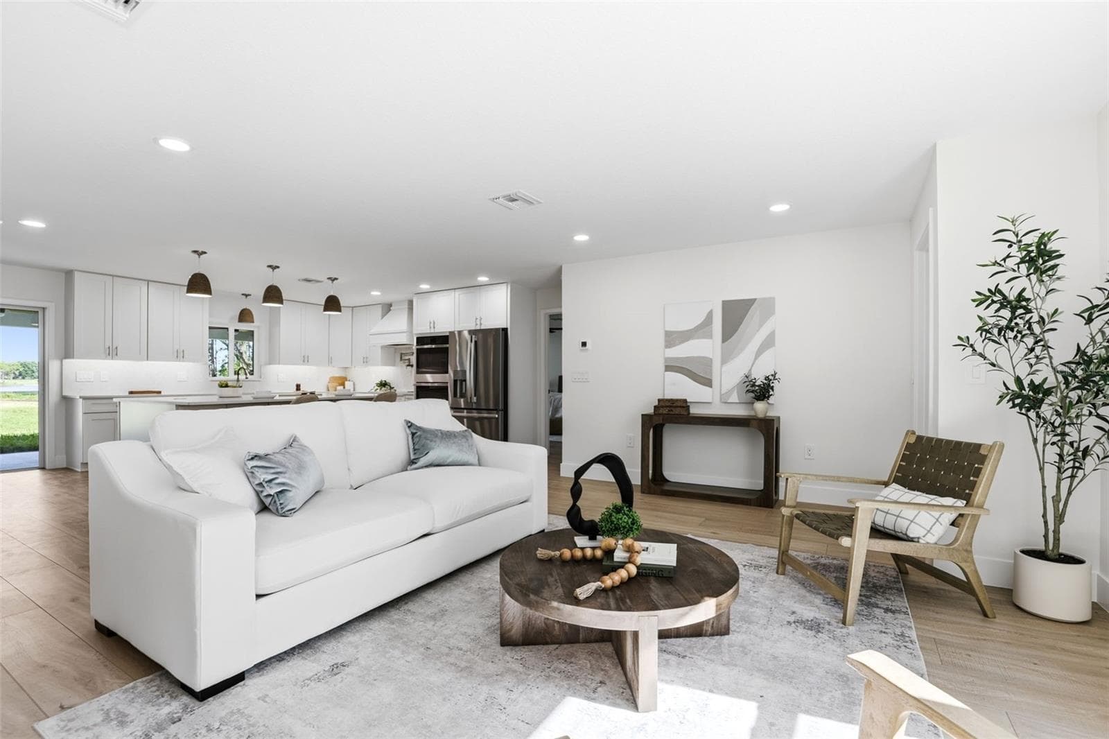 The heart of the home, this welcoming living room offers an open-concept design, abundant natural light, - 39251 COUNTY ROAD 439, UMATILLA