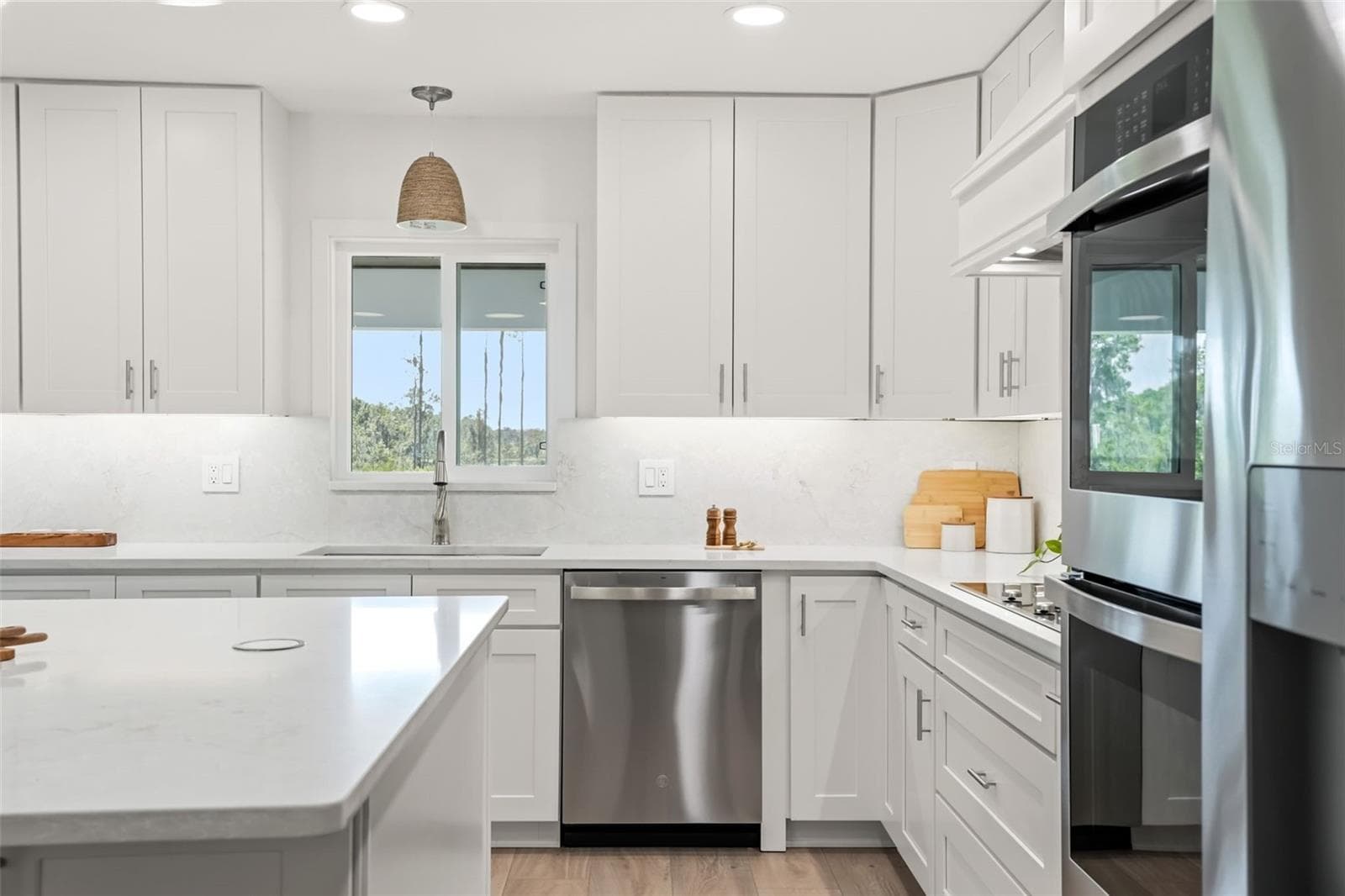 Beautiful kitchen details including custom cabinetry, quartz countertops, built-in appliances, and abundant workspace. - 39251 COUNTY ROAD 439, UMATILLA
