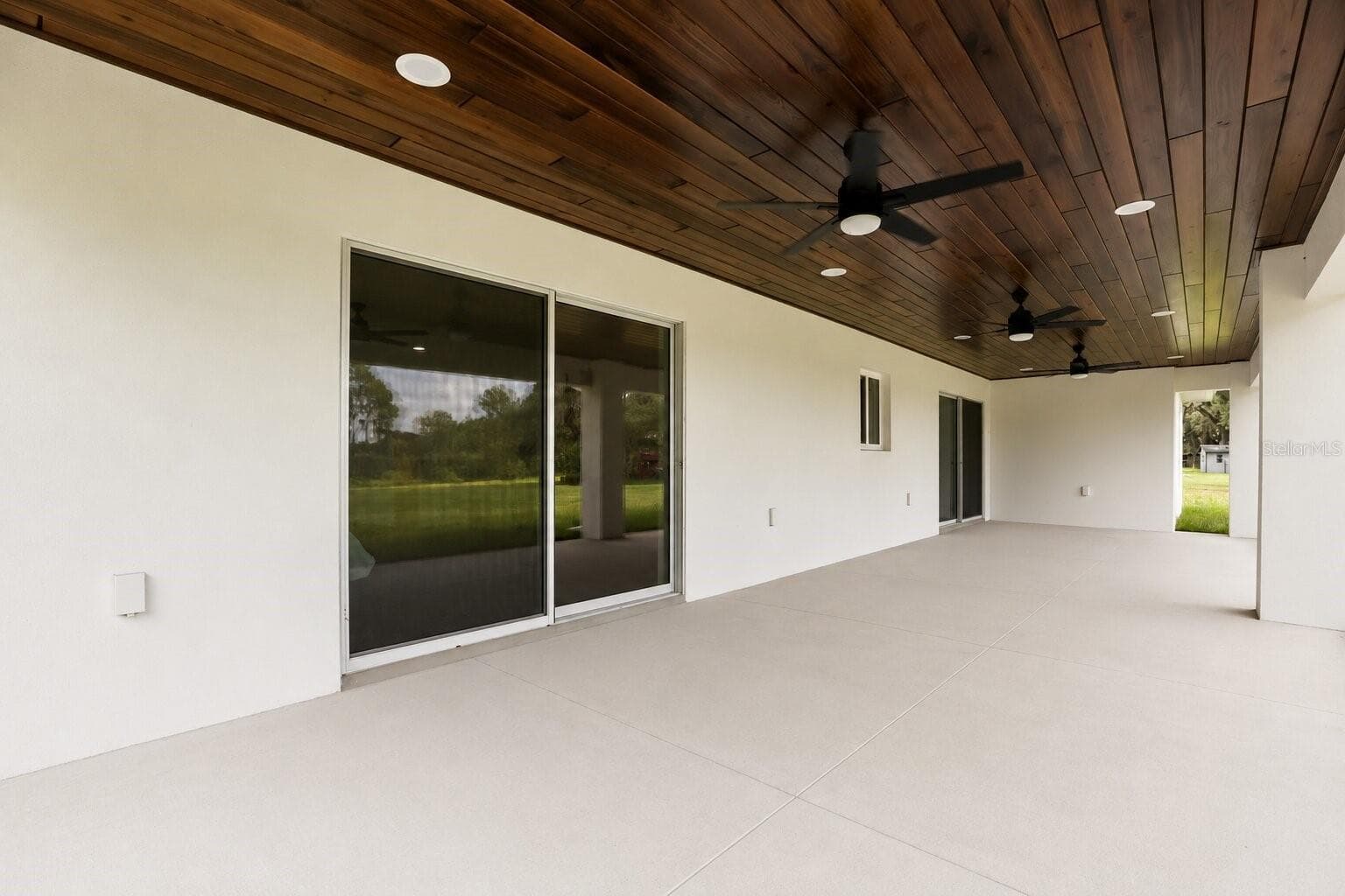 Another view emphasizing the spacious outdoor living area and direct access through the sliding glass doors. - 39251 COUNTY ROAD 439, UMATILLA
