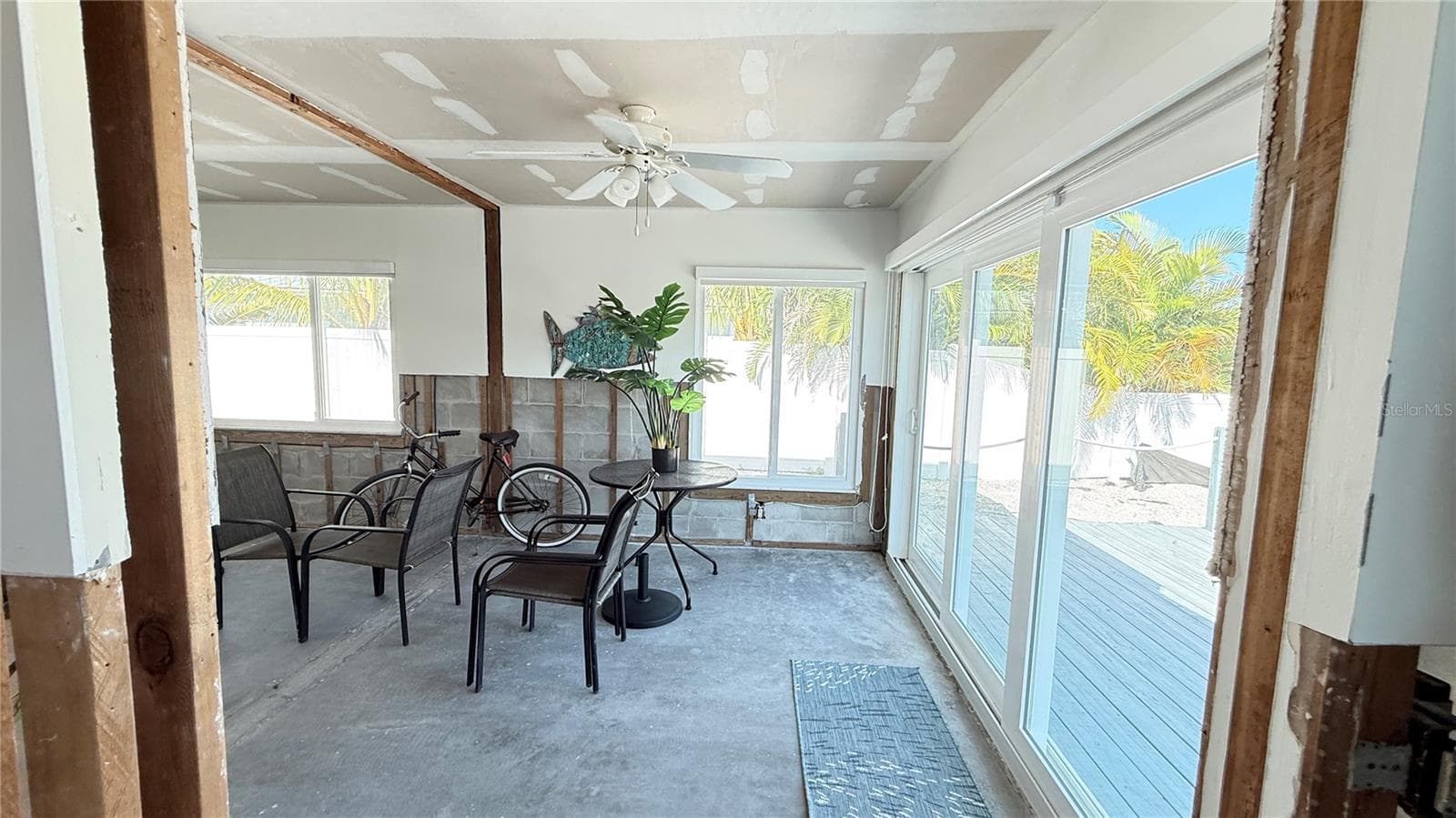 Sliding doors that lead to the wooden deck and seawall. - 420 63RD ST #420A, HOLMES BEACH