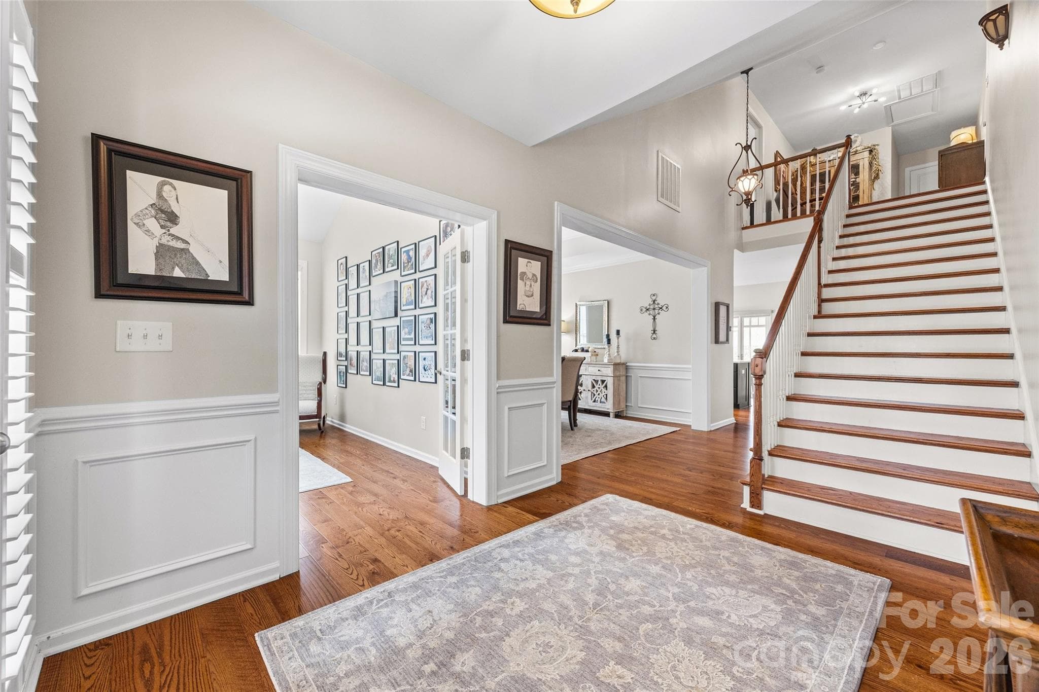Wide, open staircase with hardwood treads. - 8621 Sequoia Grove Lane, Charlotte