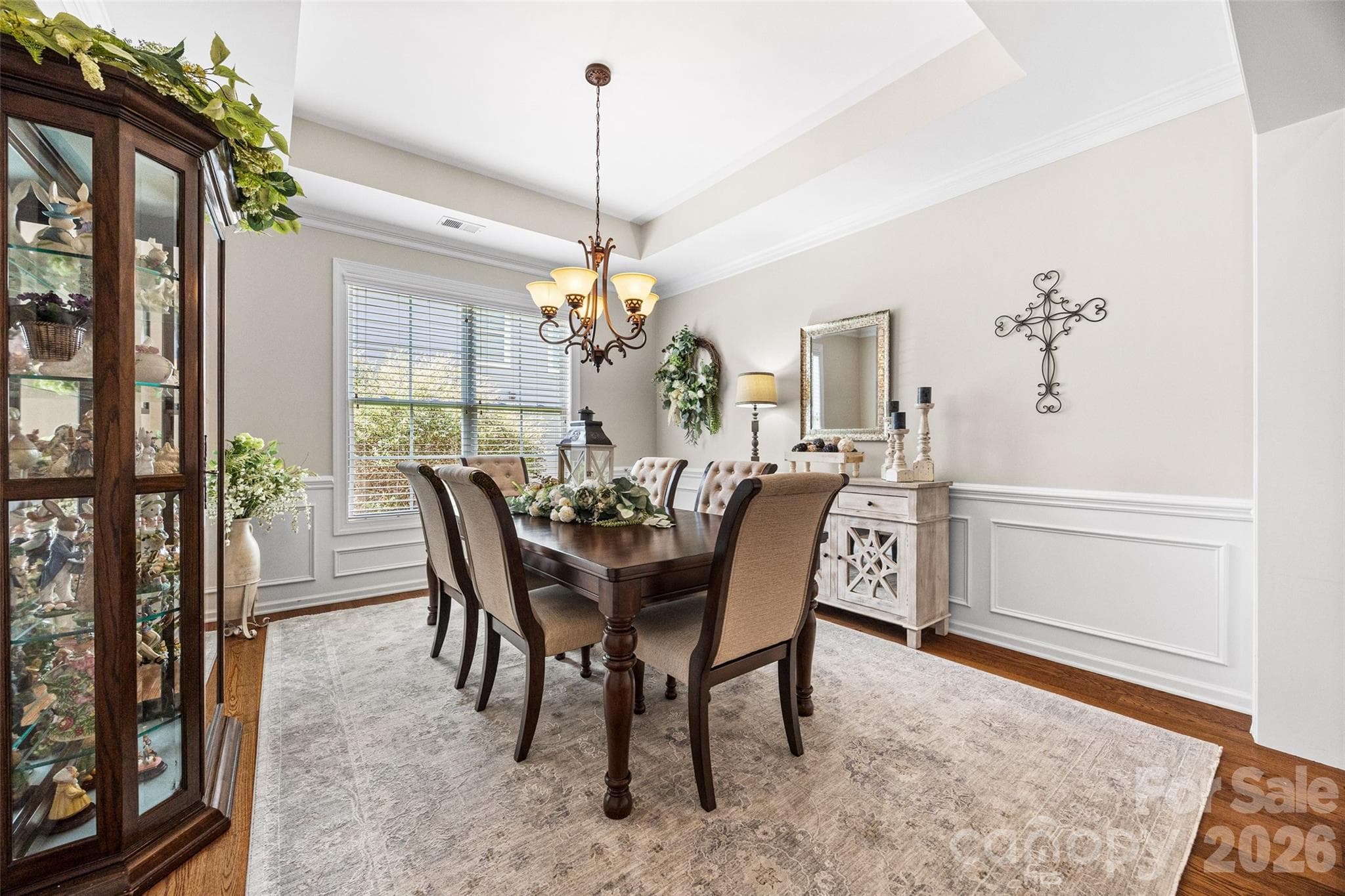 Intimate dining room, with detailed wainscoting and a beautiful tray ceiling. - 8621 Sequoia Grove Lane, Charlotte
