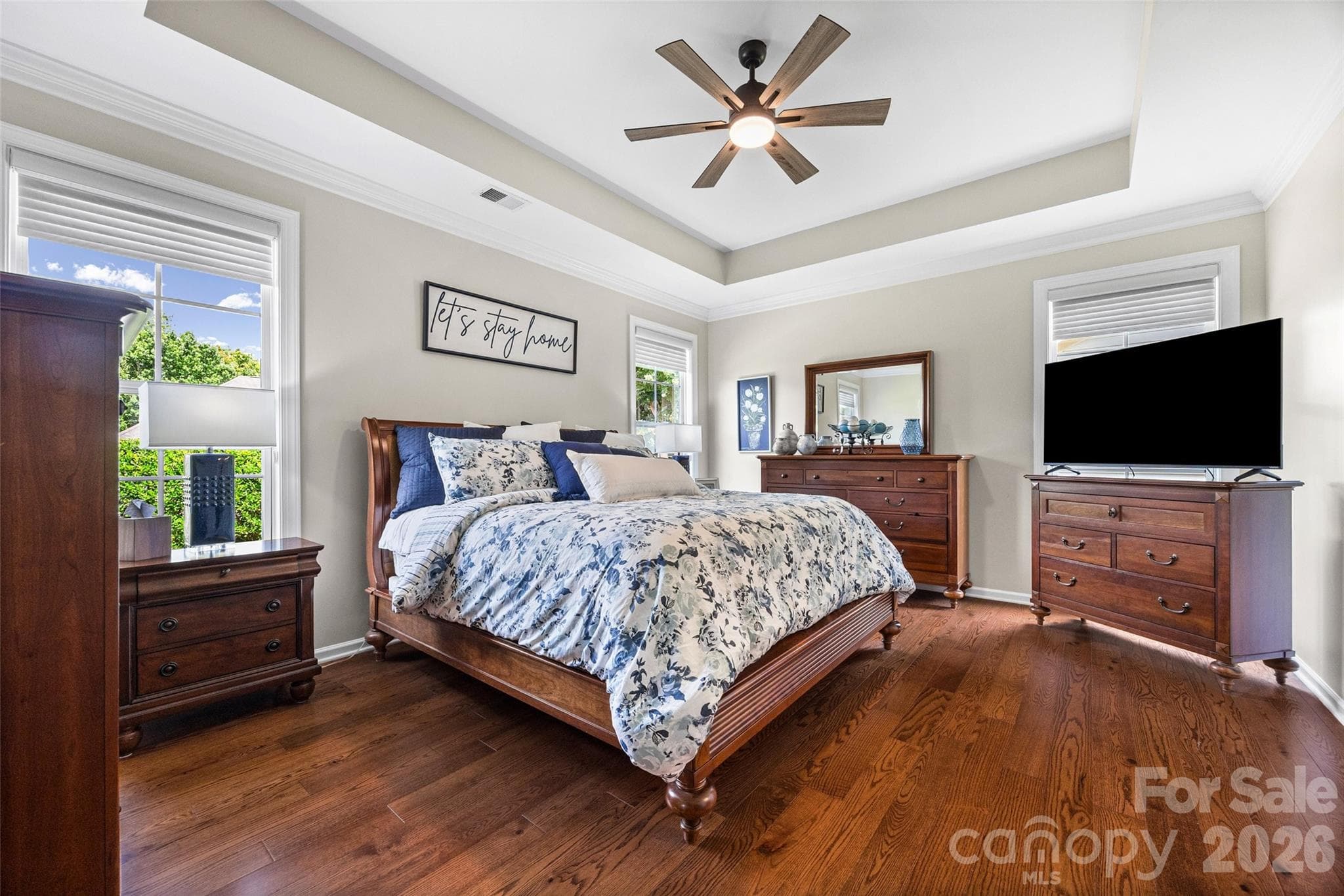 Large primary suite with lovely tray ceiling and custom sheer window treatments. - 8621 Sequoia Grove Lane, Charlotte