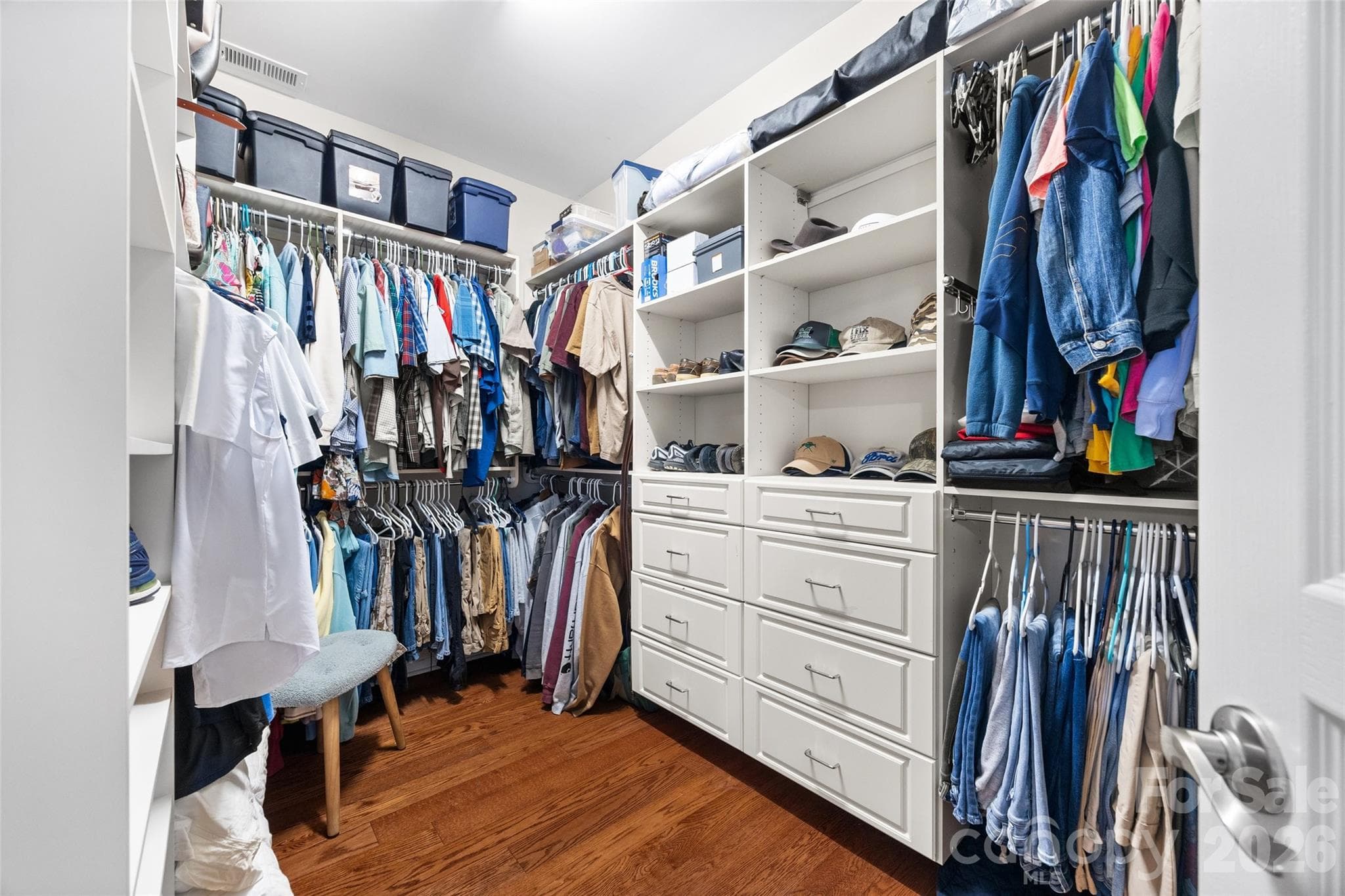 Large custom walk-in closet with built-in cabinetry. - 8621 Sequoia Grove Lane, Charlotte