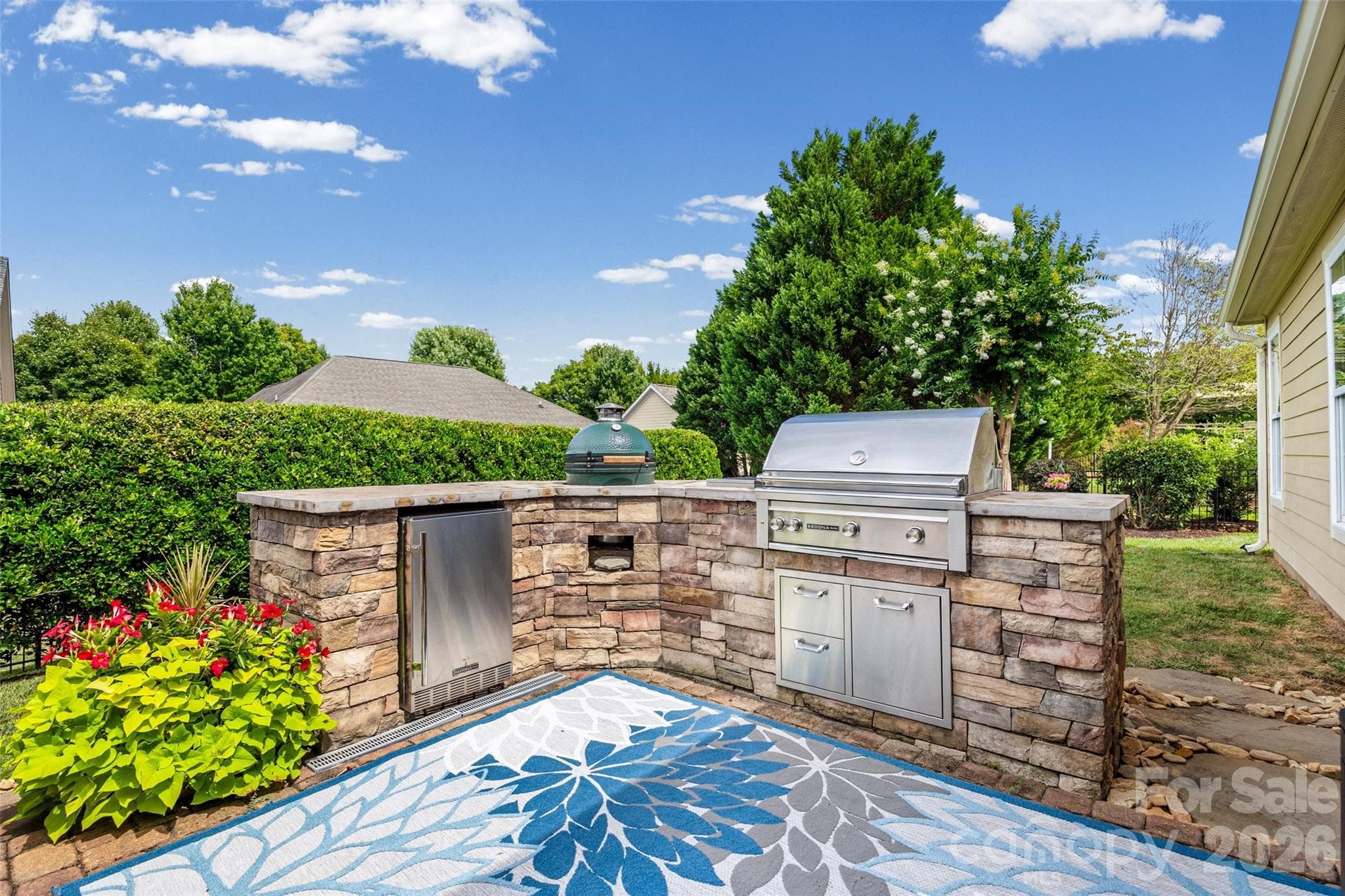 Fabulous outdoor kitchen with a regular ss grill, a Big Green Egg and a ss mini refrigerator. - 8621 Sequoia Grove Lane, Charlotte