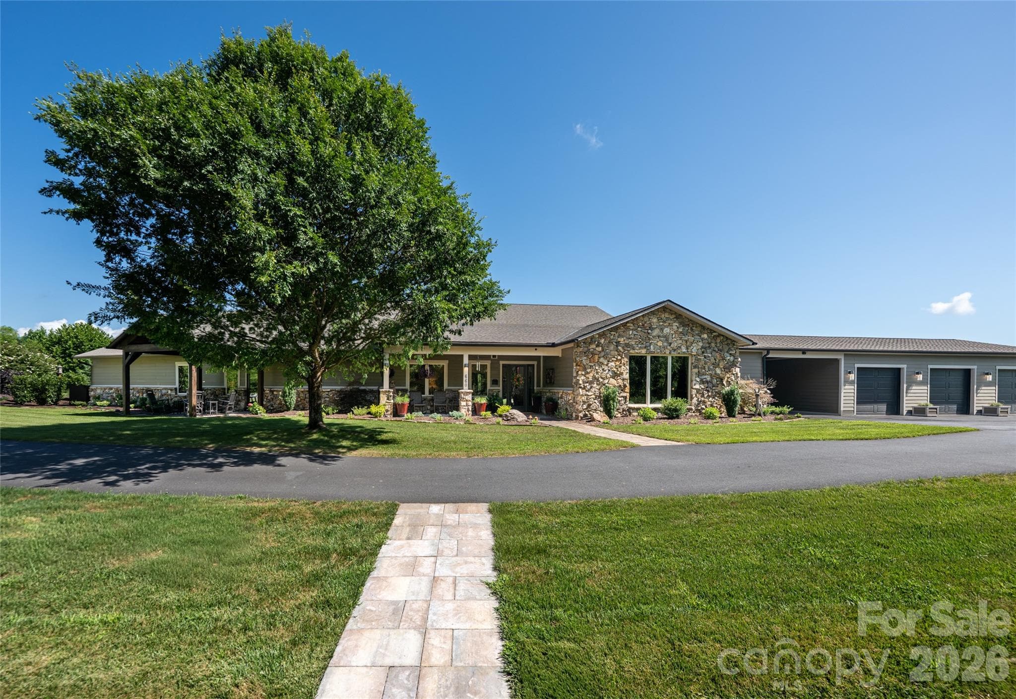 This one level home boasting over 5000 SF has an attached three car garage and a carport. - 660 Pleasant Grove Road, Hendersonville