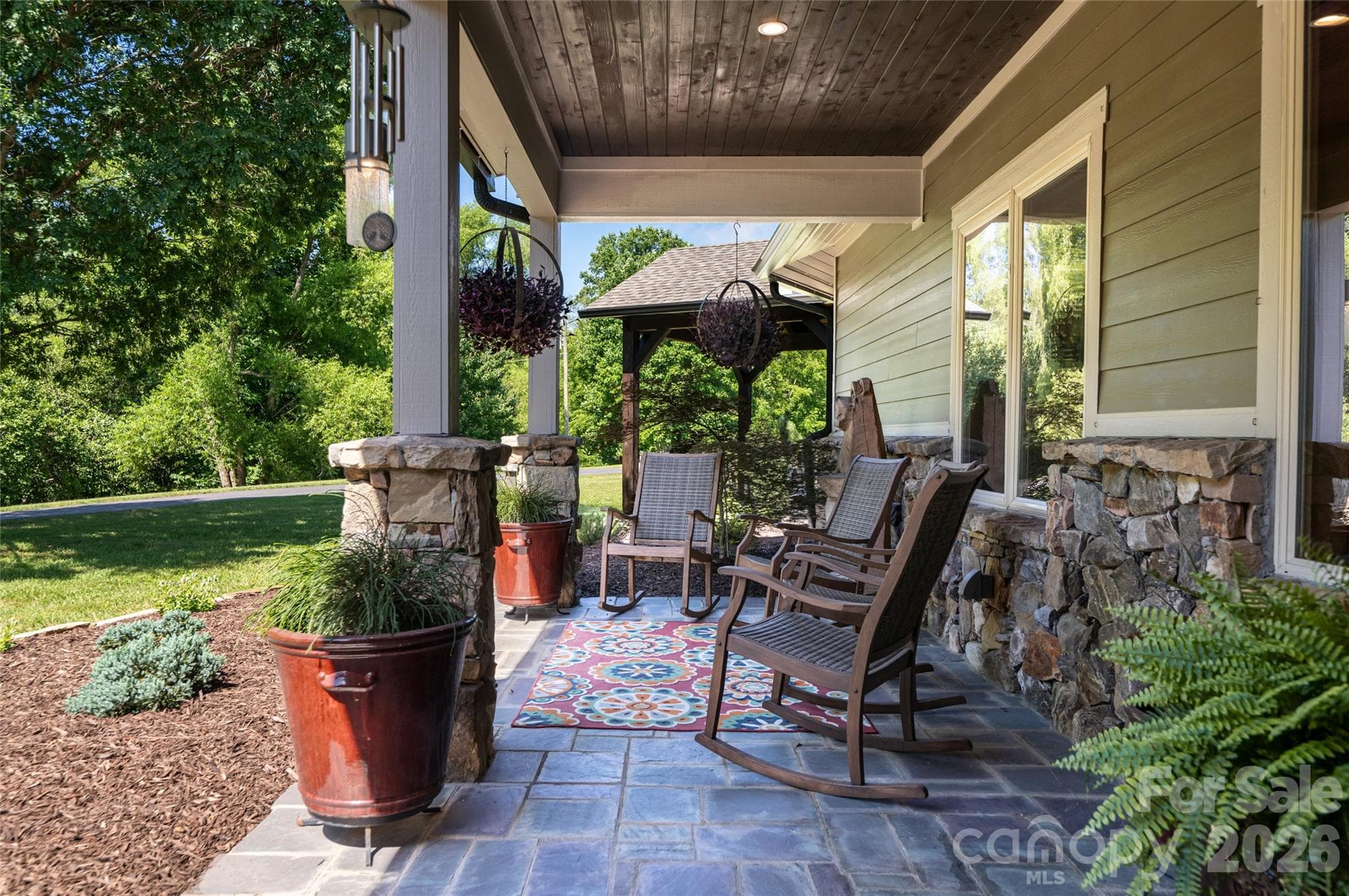 The front porch is the perfect place for morning coffee or an afternoon read. - 660 Pleasant Grove Road, Hendersonville
