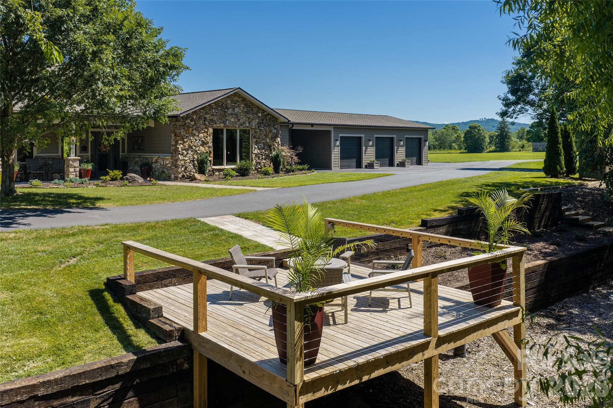 Or just a few steps away is a deck overlooking a small creek. - 660 Pleasant Grove Road, Hendersonville