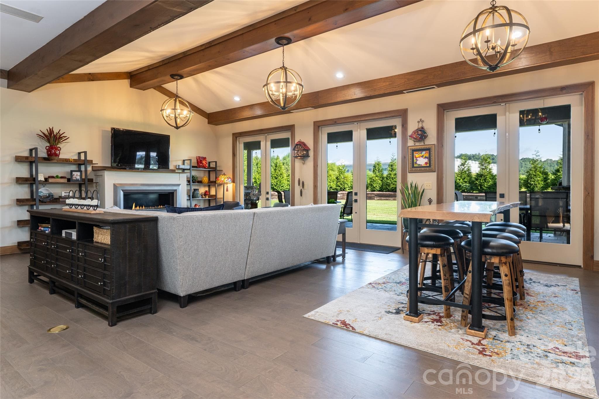 Living room looking out three French doors to a large entertaining patio and mountain view! - 660 Pleasant Grove Road, Hendersonville