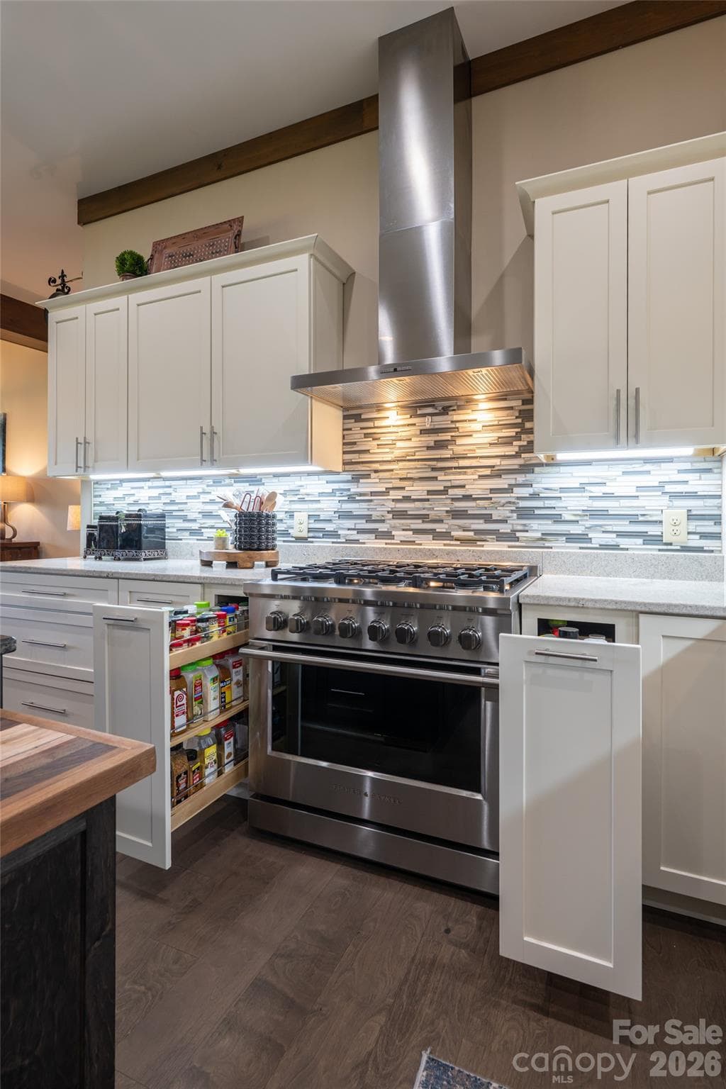 Dual pull-out spice drawers flank the range, offering smart storage and quick access while cooking. - 660 Pleasant Grove Road, Hendersonville