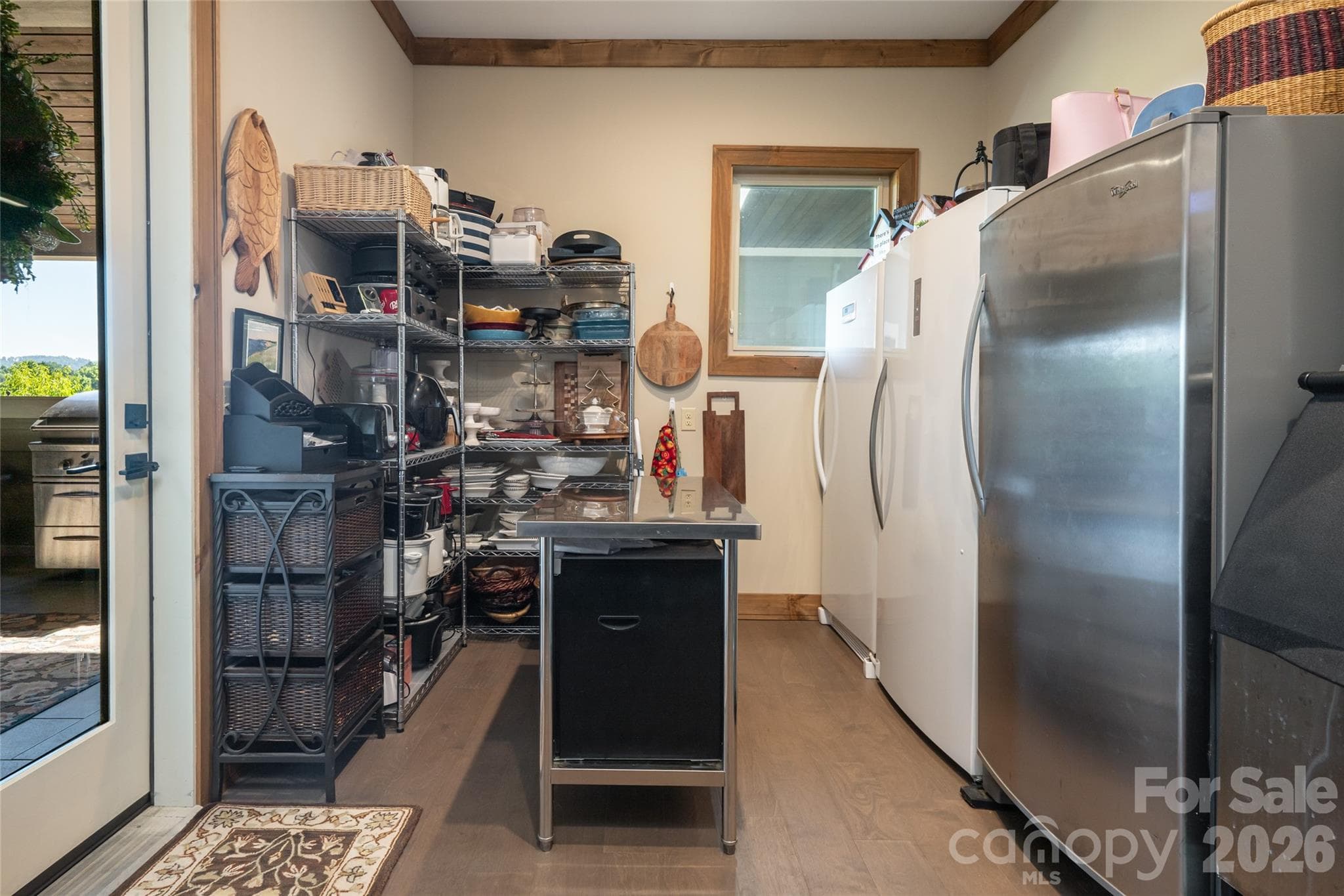 Large walk-in pantry with ample space for food storage, entertaining supplies, and an additional refrigerator or freezer. - 660 Pleasant Grove Road, Hendersonville