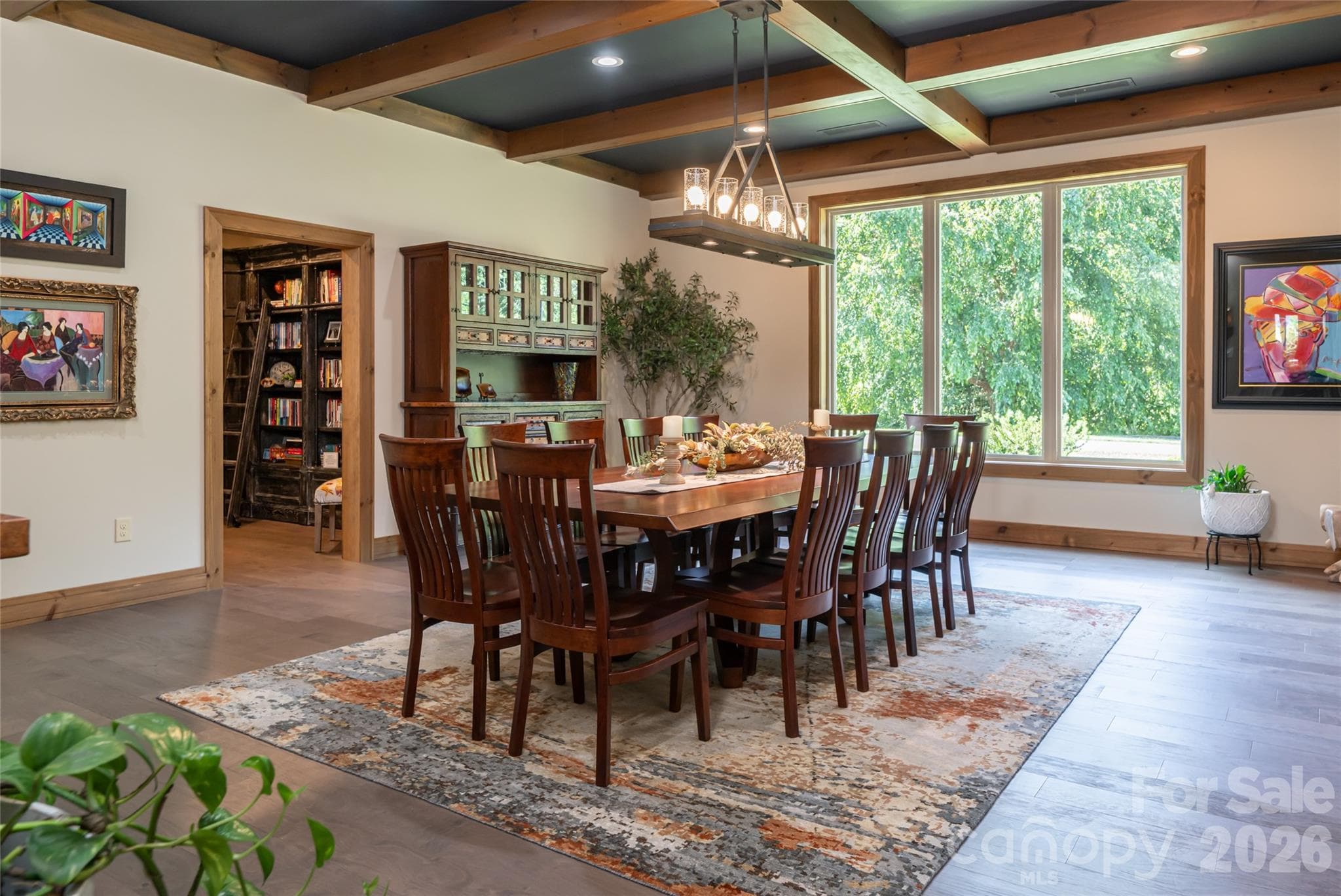 Expansive dining room with original beams, 10-foot ceilings, and seating for 12+. Could easily be used as a spacious den or family room if a large dining room isn't needed. - 660 Pleasant Grove Road, Hendersonville