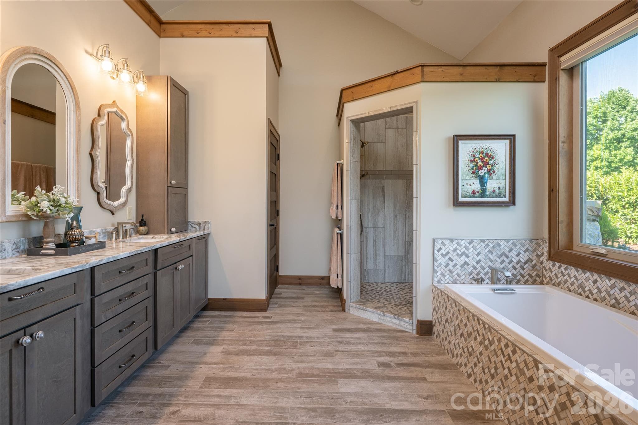 Primary bath with heated floors, a large soaking tub and walk-in shower with dual shower heads. - 660 Pleasant Grove Road, Hendersonville