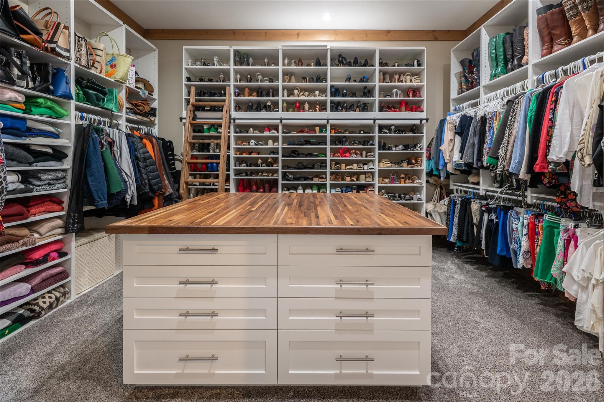 HER walk-in closet with large island with drawers on each side. - 660 Pleasant Grove Road, Hendersonville
