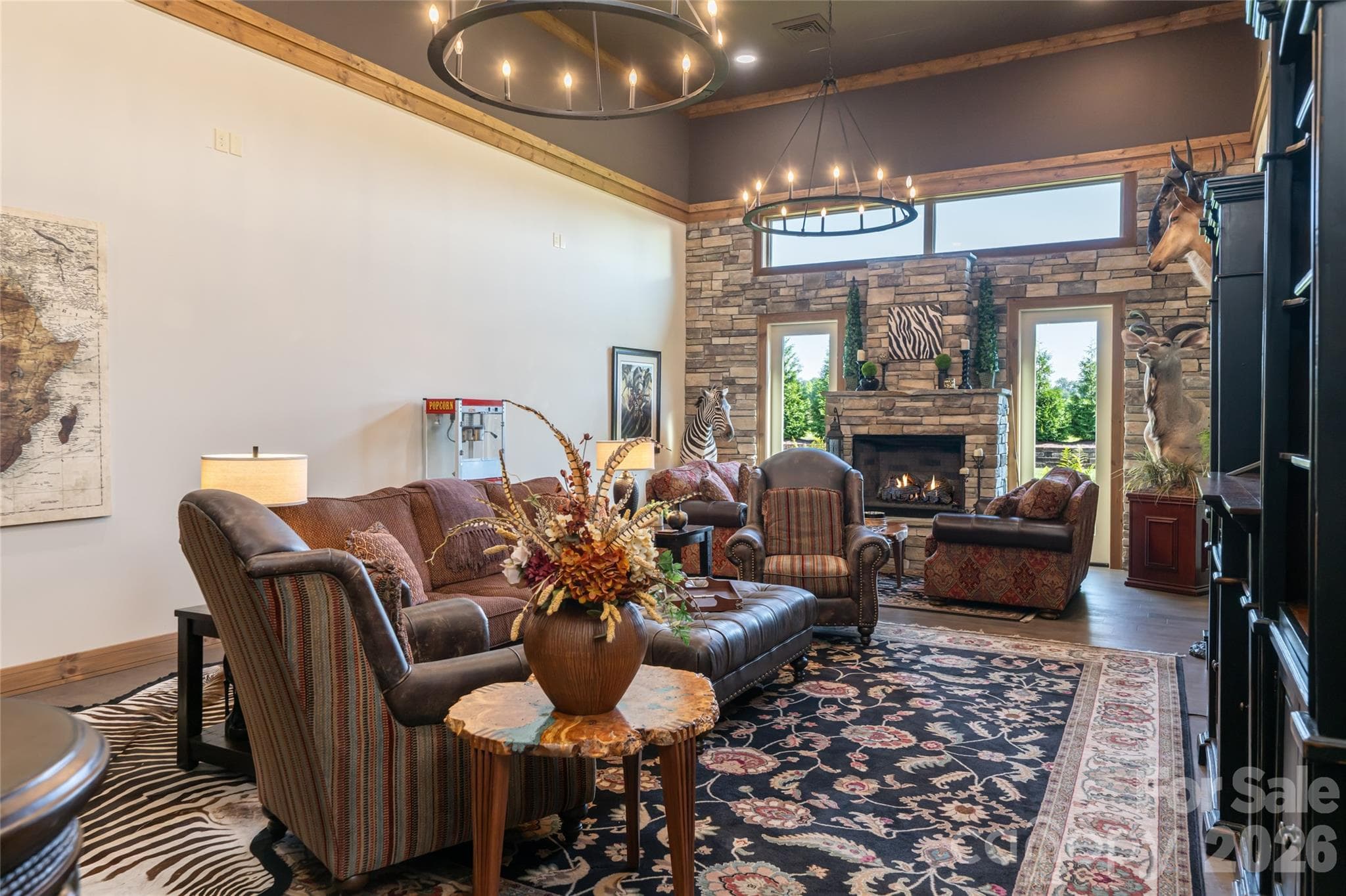 Expansive den with 16-foot ceilings and gas fireplace, offering potential for conversion to a fourth bedroom with private bath. - 660 Pleasant Grove Road, Hendersonville