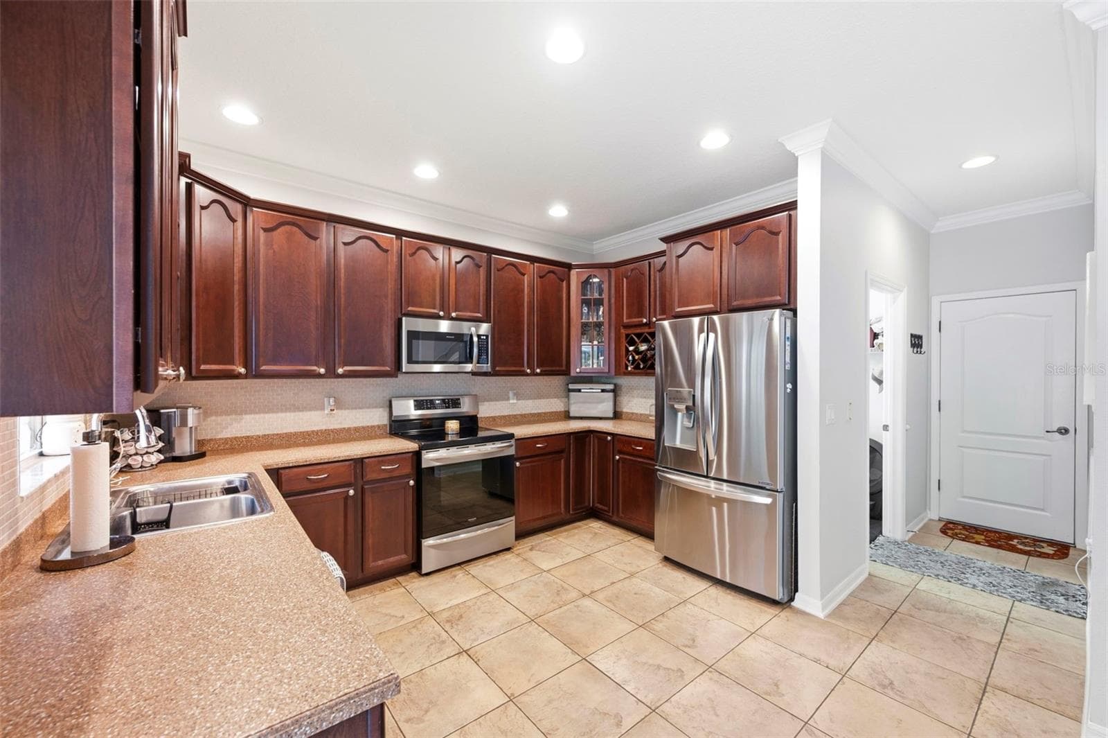 Door from kitchen leads to the garage. - 11507 BELLE HAVEN DR, NEW PORT RICHEY