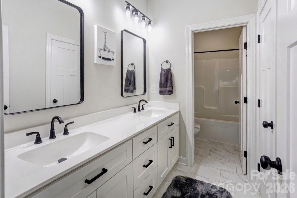 Upstairs guest bath with double vanity, linen closet and private tub/shower room. - 317 Oak Brook Drive, Salisbury