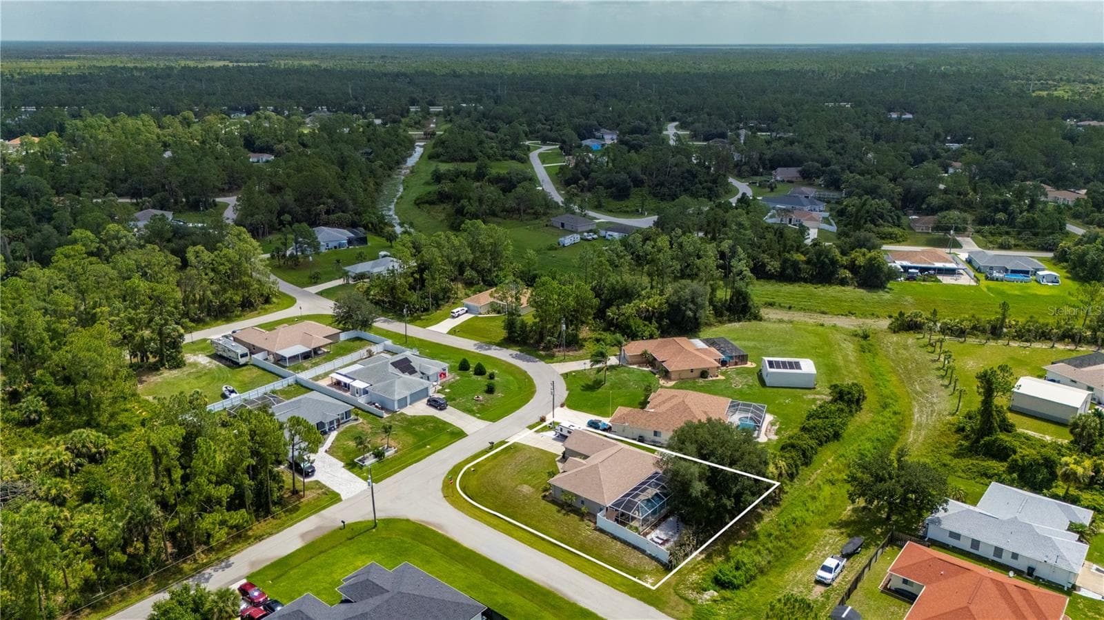 View of this beautiful pool home on a corner lot and looking Northeast. - 5615 MOJAVE AVE, NORTH PORT