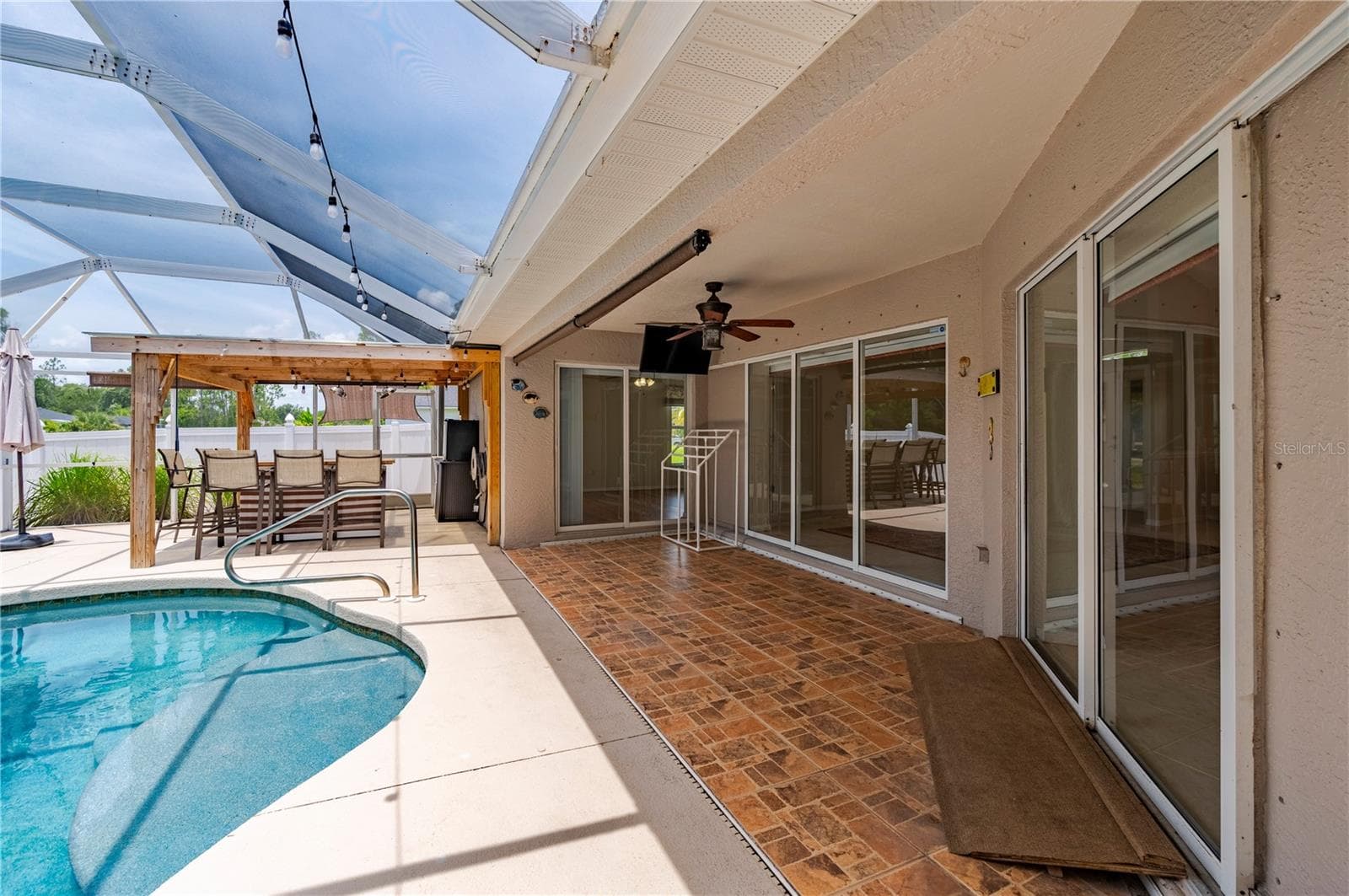 Step out to this sparkling pool and summer kitchen - 5615 MOJAVE AVE, NORTH PORT