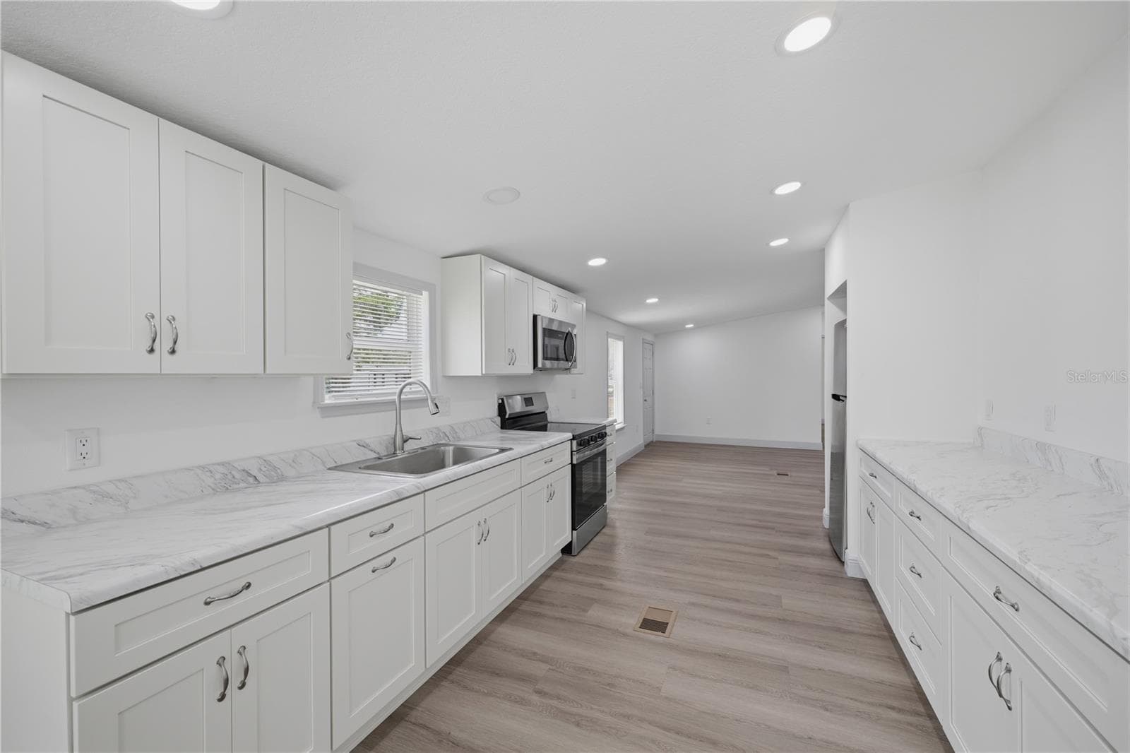 kitchen with lots of counter space and cabinets - 7904 CADILLAC AVE, HUDSON