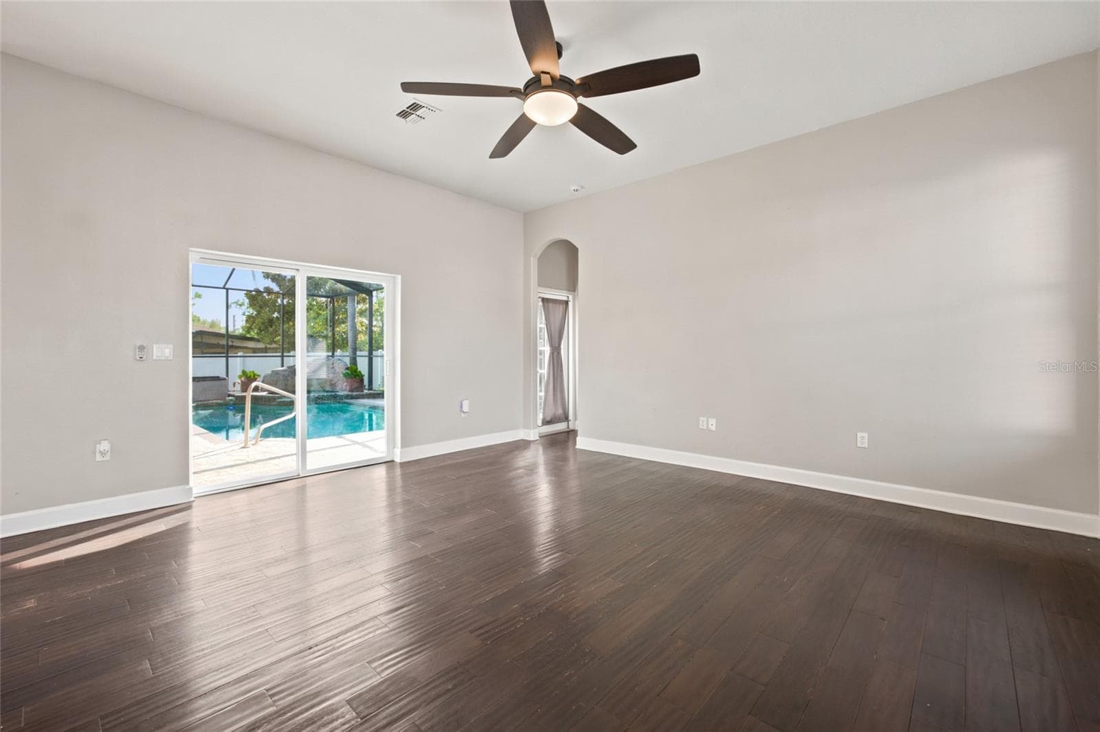 Family Room Overlooks Pool and open to Kitchen - 5517 GREYSTONE DR, SPRING HILL