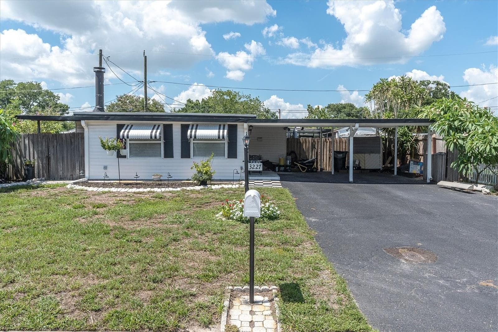Front Exterior with oversized driveway and carport - 3227 48TH AVE N, ST PETERSBURG