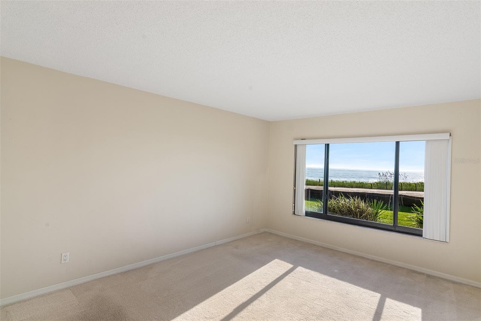 East facing primary bedroom - 2600 OCEAN SHORE BLVD #111, ORMOND BEACH