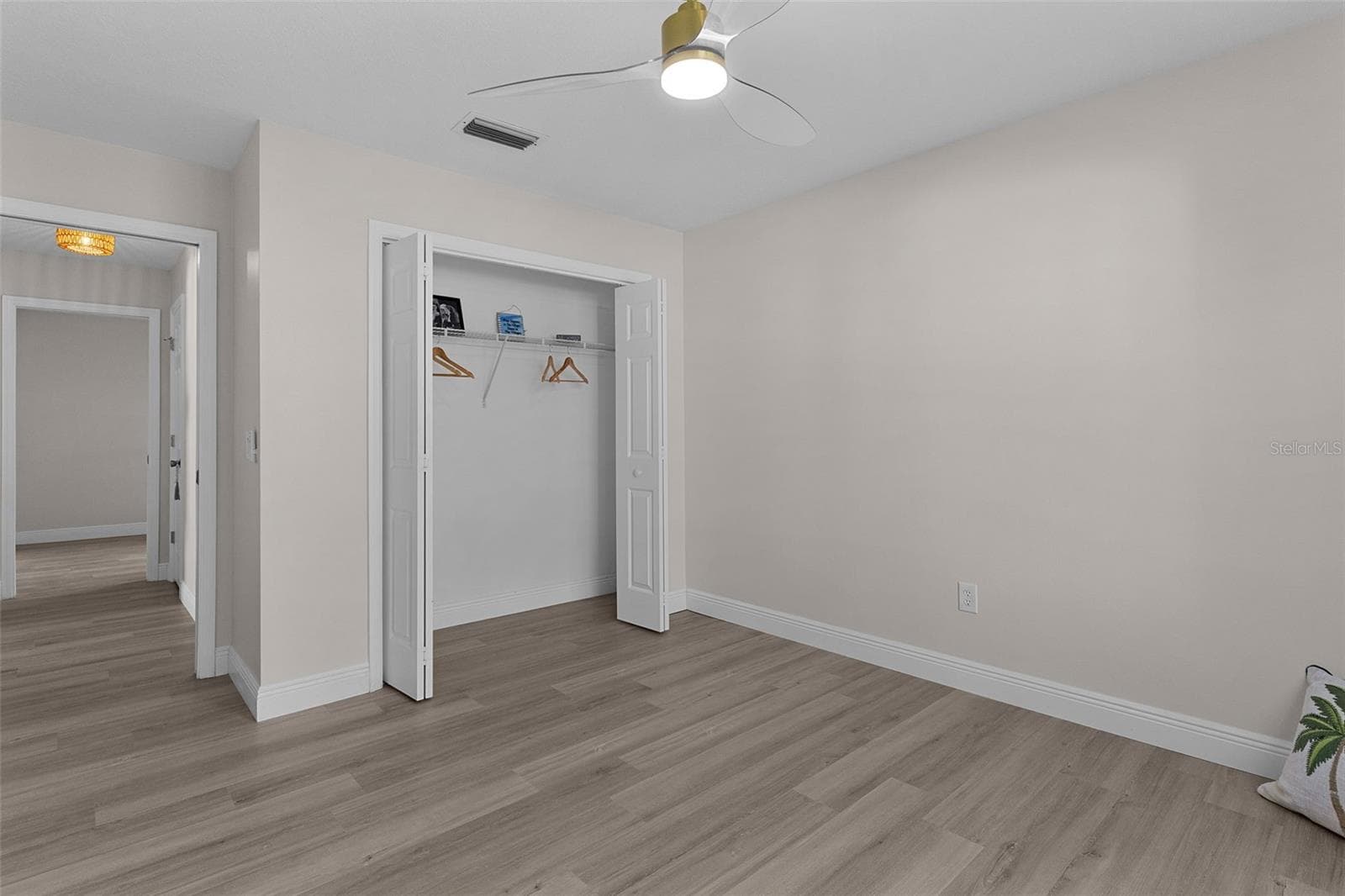 Guest bedroom one with closet and new lighted fan. - 1012 DIEGO CT, LADY LAKE