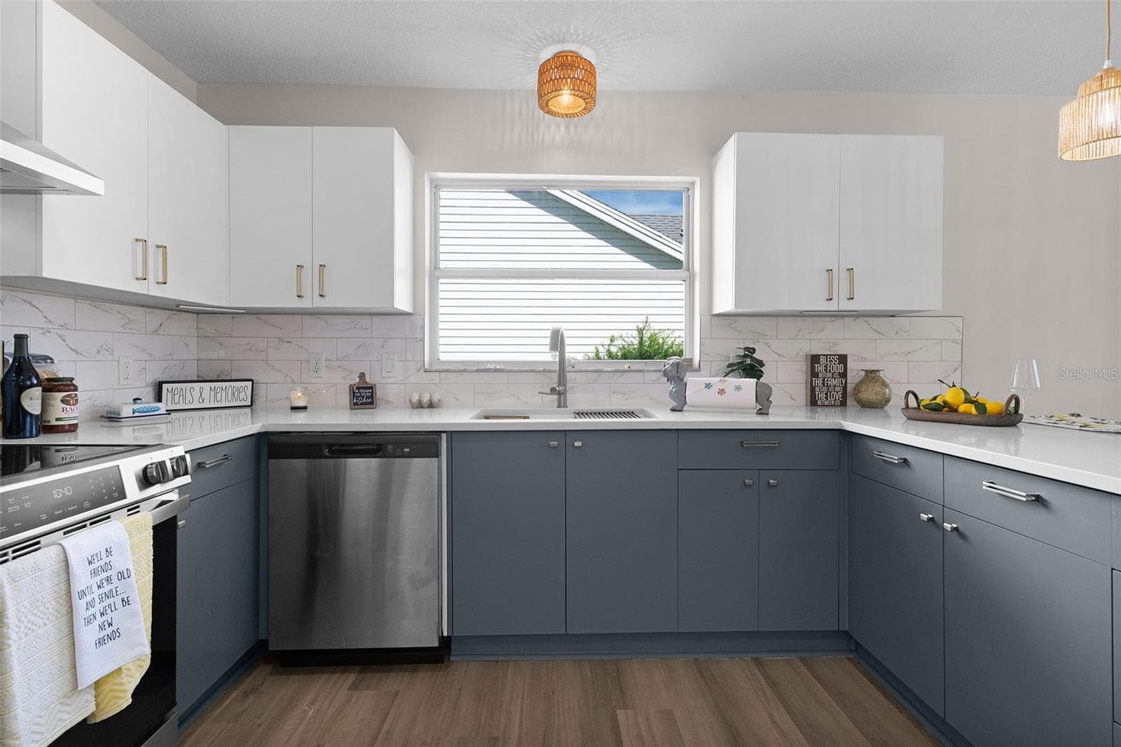 Brand new kitchen with new stainless steel appliances, range hood, quartz countertops, and tile backsplash. - 1012 DIEGO CT, LADY LAKE