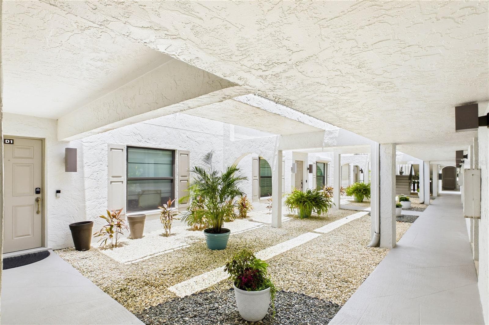 Covered walkway leading to the private second-floor entrance - 4218 SE 20TH PL #D5, CAPE CORAL