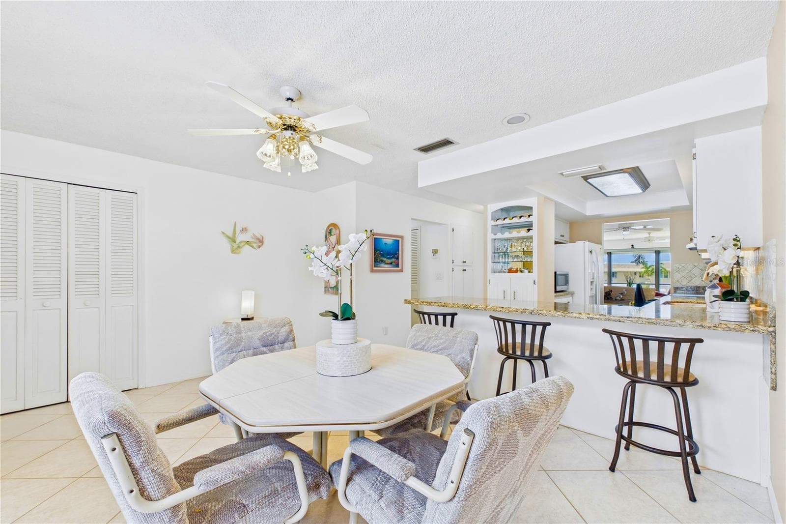 Bright dining area with an open flow to the kitchen and breakfast bar seating - 4218 SE 20TH PL #D5, CAPE CORAL