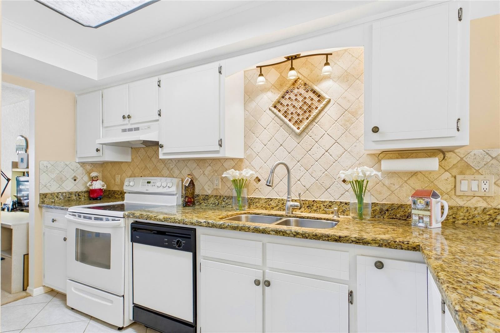 Tiled backsplash and tray ceiling detail give it a polished look - 4218 SE 20TH PL #D5, CAPE CORAL