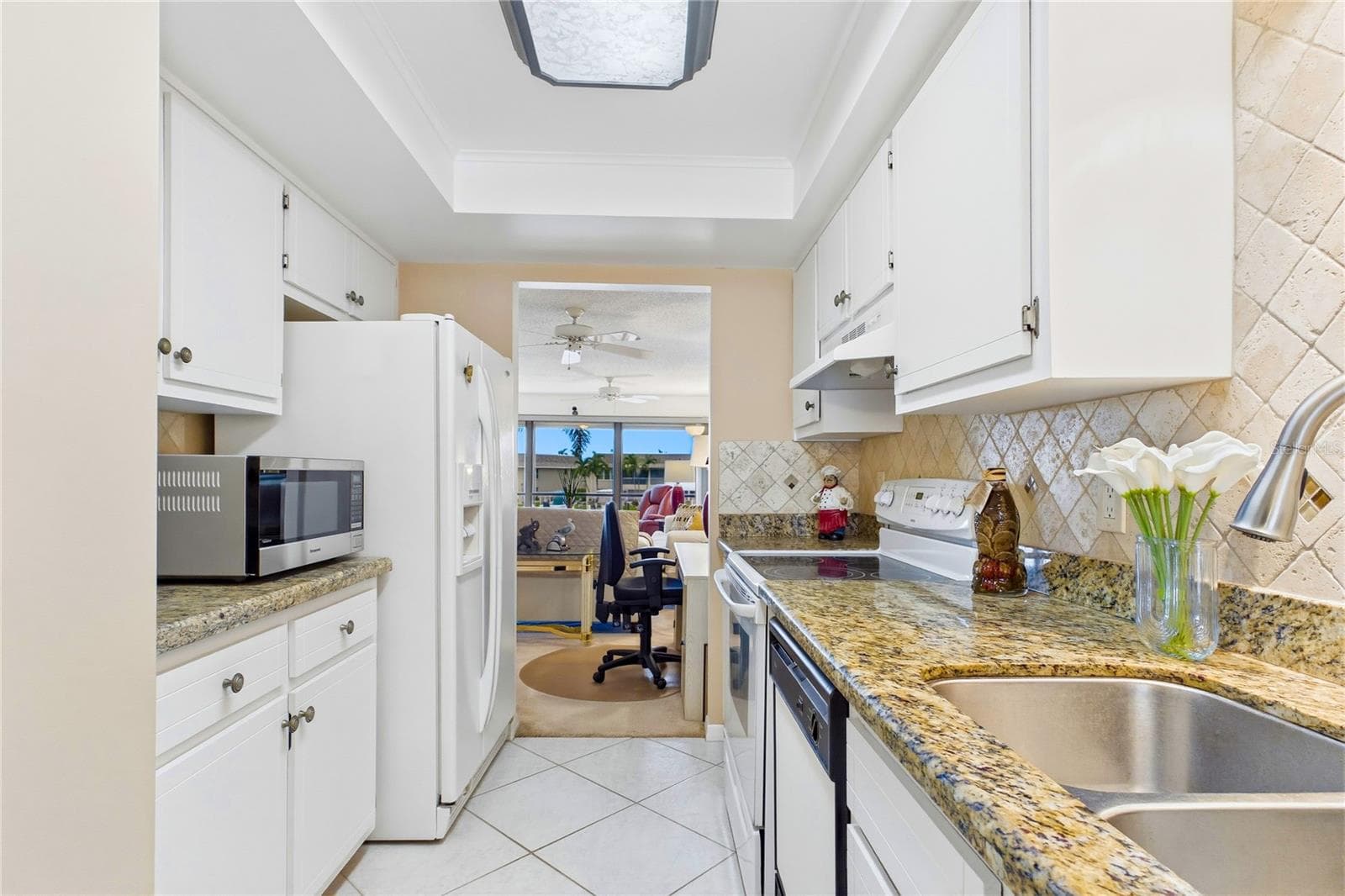 Open sightlines connect the kitchen to the dining area and living space - 4218 SE 20TH PL #D5, CAPE CORAL