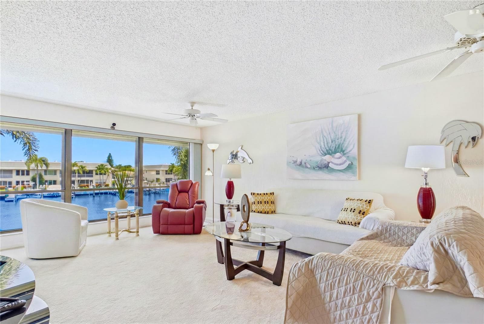 The generous living room is filled with natural light and CAPTIVATING WATER VIEWS, making it ideal for entertaining or peaceful evenings at home! - 4218 SE 20TH PL #D5, CAPE CORAL
