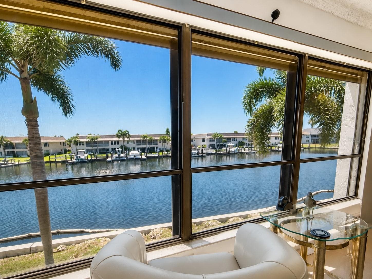 The living room is perfectly positioned to capture serene long-water views, bringing natural light and a relaxing waterfront backdrop indoors. - 4218 SE 20TH PL #D5, CAPE CORAL