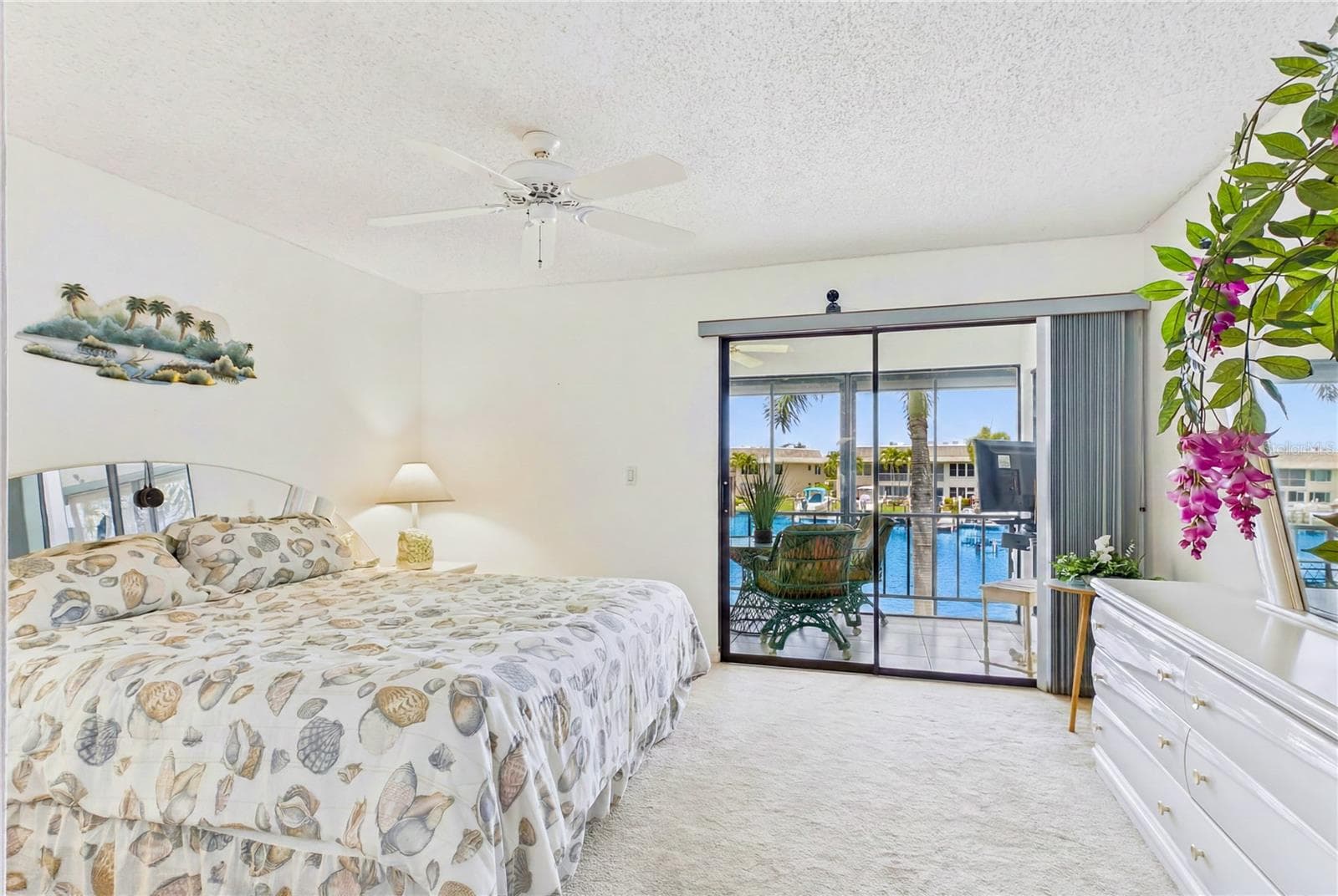 From the primary suite, you have direct access to the SCREENED BALCONY overlooking the wide canal! - 4218 SE 20TH PL #D5, CAPE CORAL