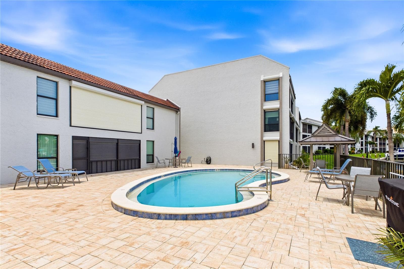 Relax and unwind at the waterfront community pool just steps from your door. - 4218 SE 20TH PL #D5, CAPE CORAL