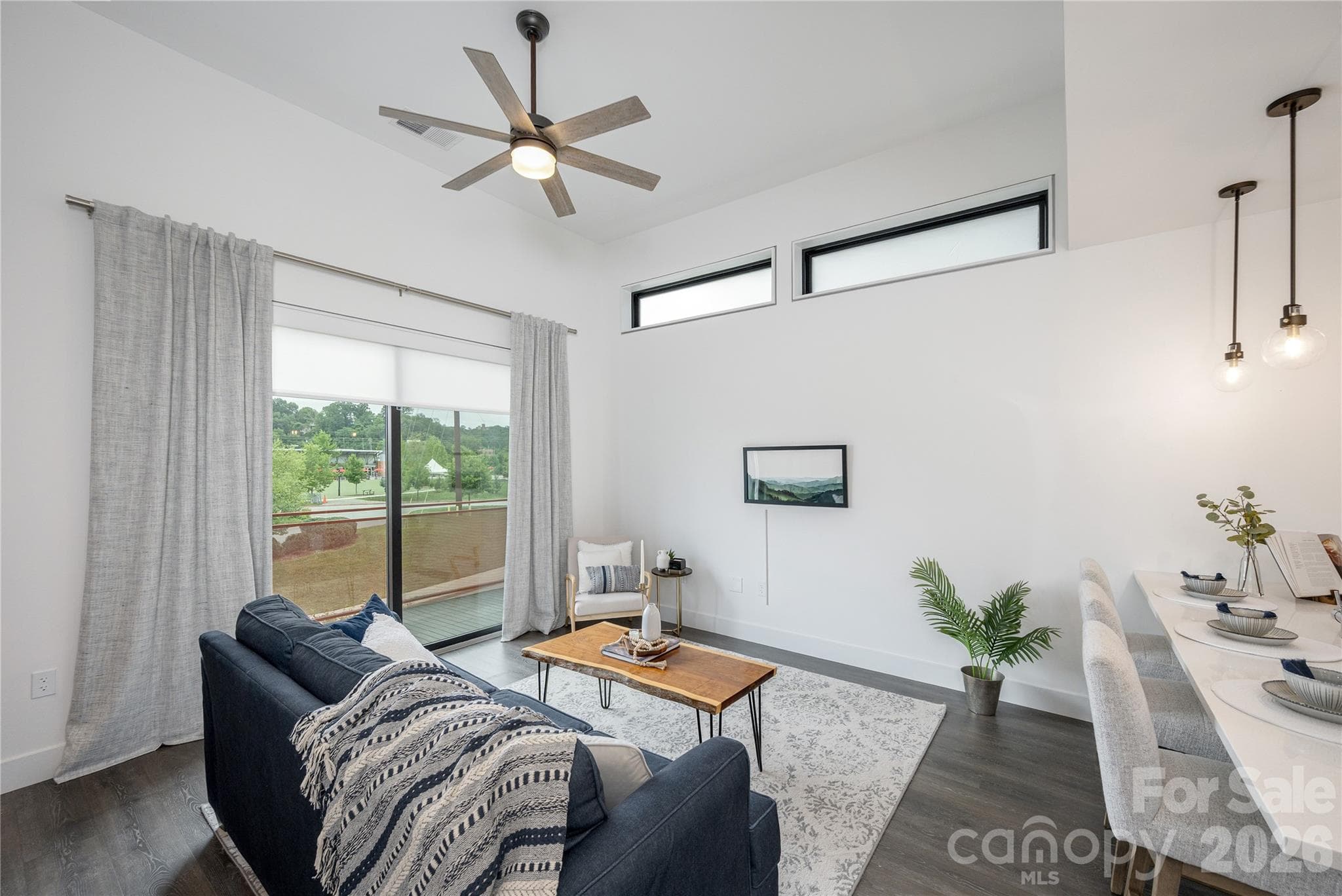 Coveted end-unit features natural light from two exposures, soaring 12-foot ceilings, modern finishes, and an open floorplan. - Asheville